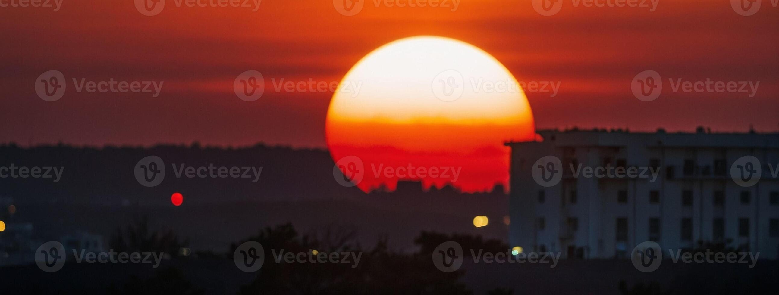 The sun sets behind the city of paris, france, on june 21, 2019 photo