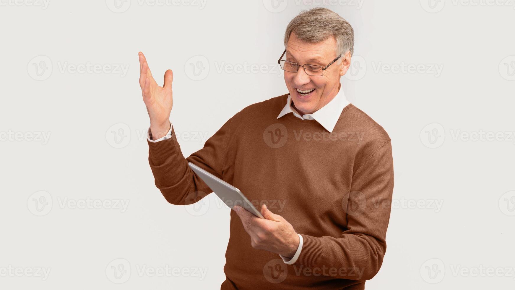 Excited Senior Man Using Digital Tablet Computer Standing Over White Studio Background. Panorama photo
