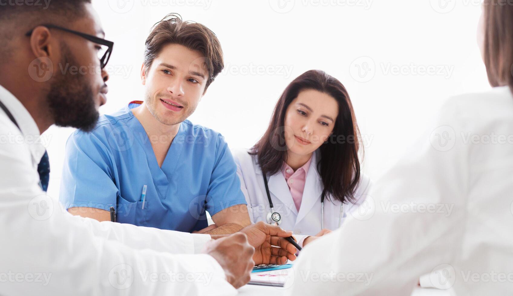 Doctors interacting at meeting in conference room, discussing diagnosis photo