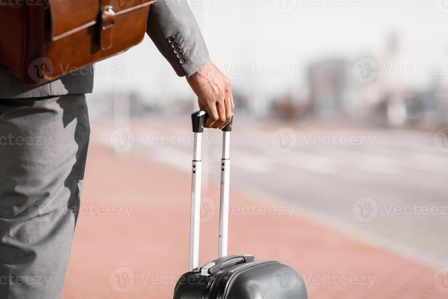 Unrecognizable businessman is walking with his luggage outside a modern airport. The mood is dynamic and professional, highlighting travel and business with a sleek airport backdrop. photo