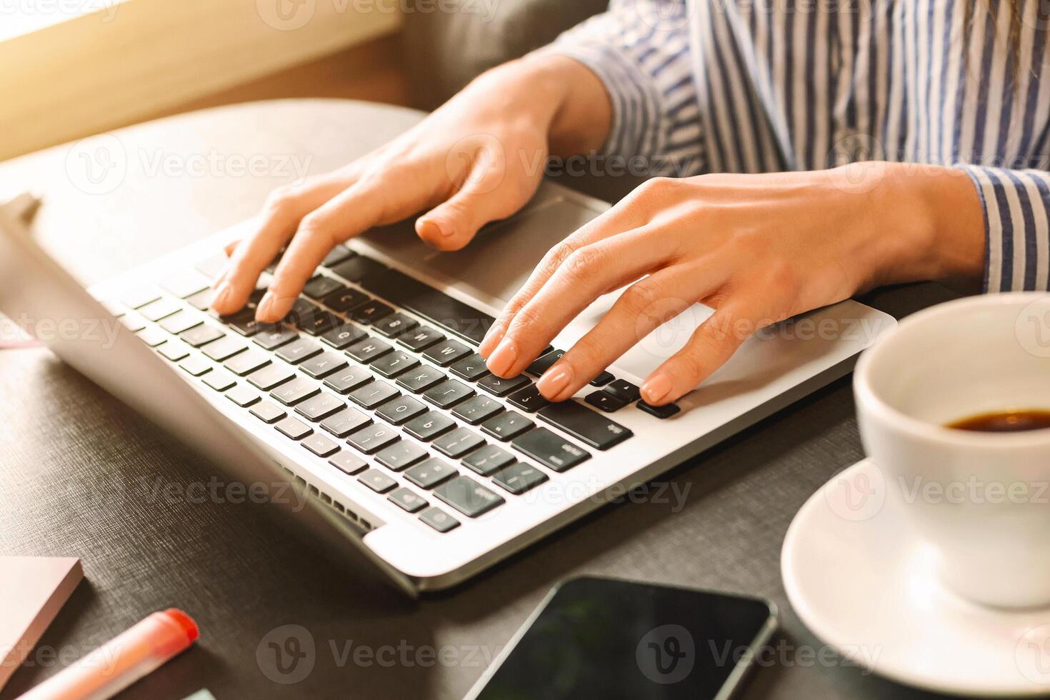 Female blogger typing on laptop, chatting with followers, preparing trendy content in cafe, empty space photo