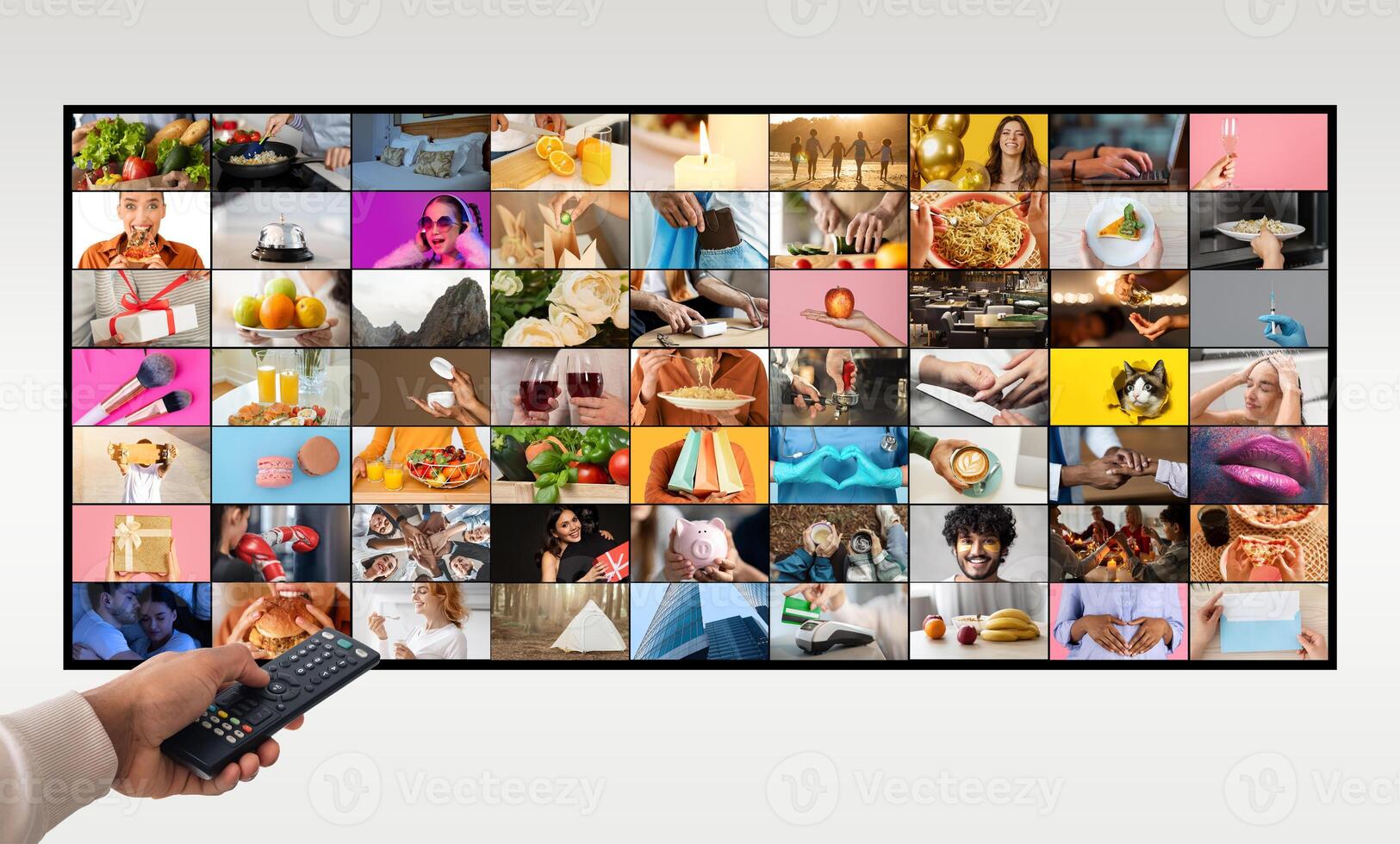 A hand holds a black remote control in front of a television screen that is displaying a variety of colorful images. The images are organized in a grid pattern and feature various scenes of people photo