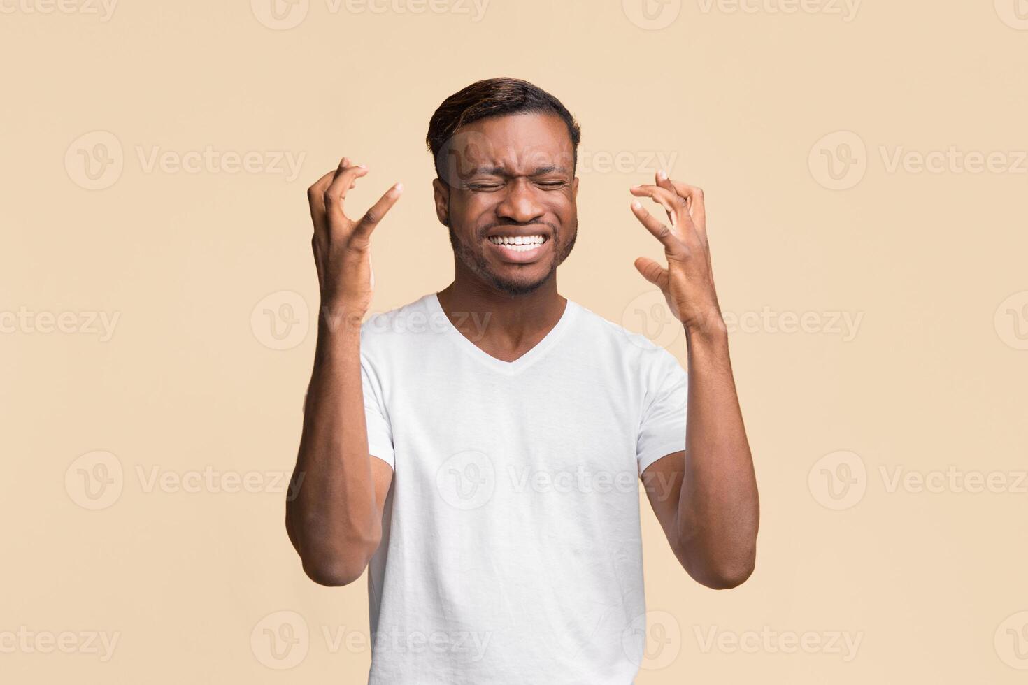 Failure. Frustrated Afro Man Gesturing With Hands Expressing Disappointment Standing Over Yellow Background. Studio Shot photo