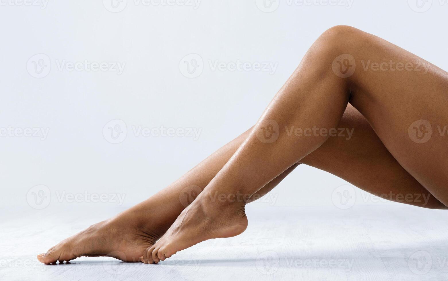Attractive legs of black woman over grey background, free space, hair removal procedures photo