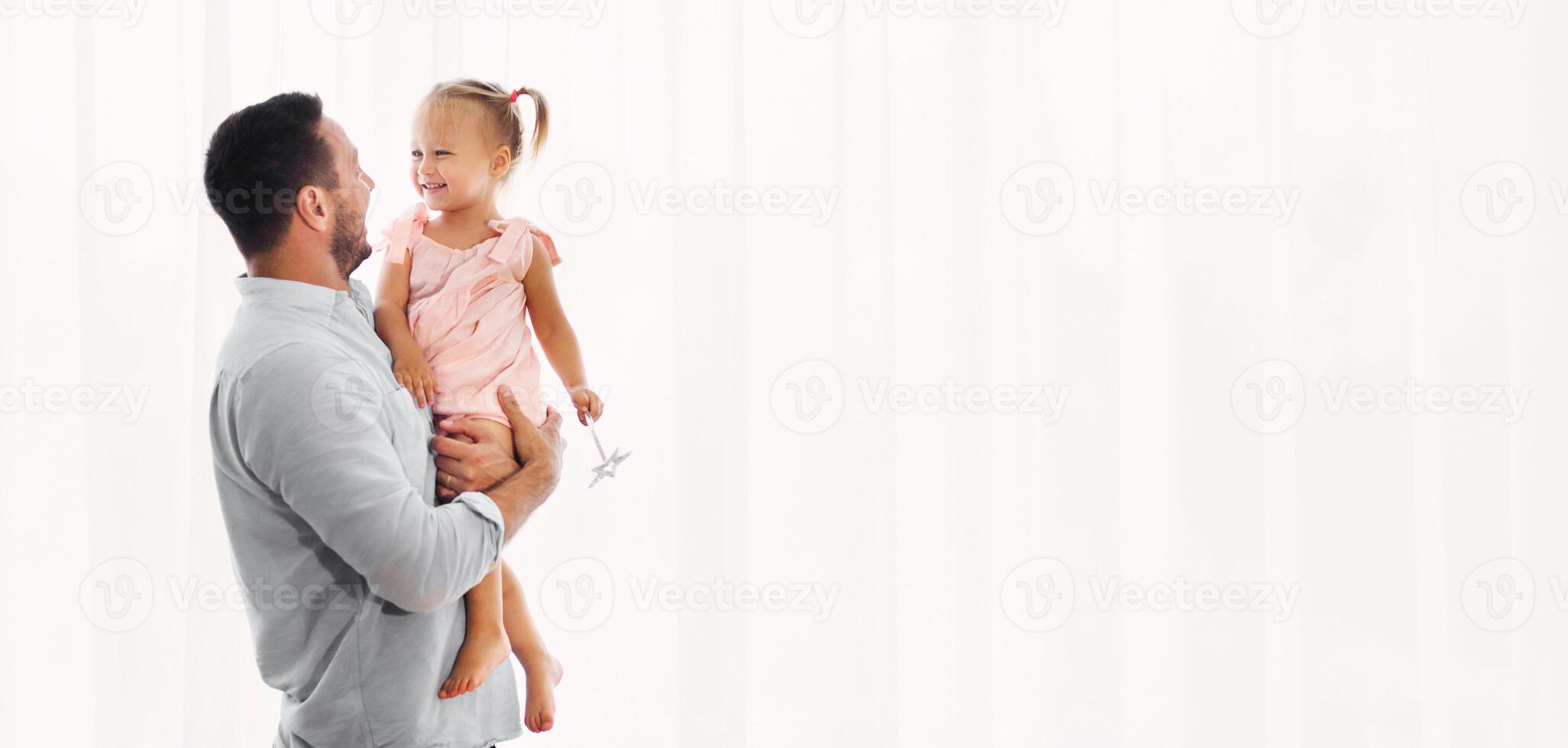 Single Parent Family. Father spending time with daughter, holding his child on hands, free space photo