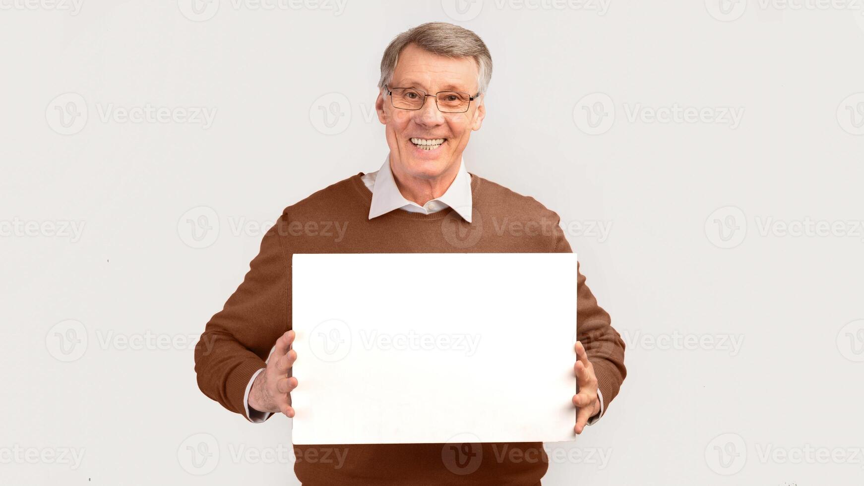 Great Offer. Cheerful Elderly Man Holding Blank Board For Text Standing Over White Studio Background. Panorama, Mockup photo
