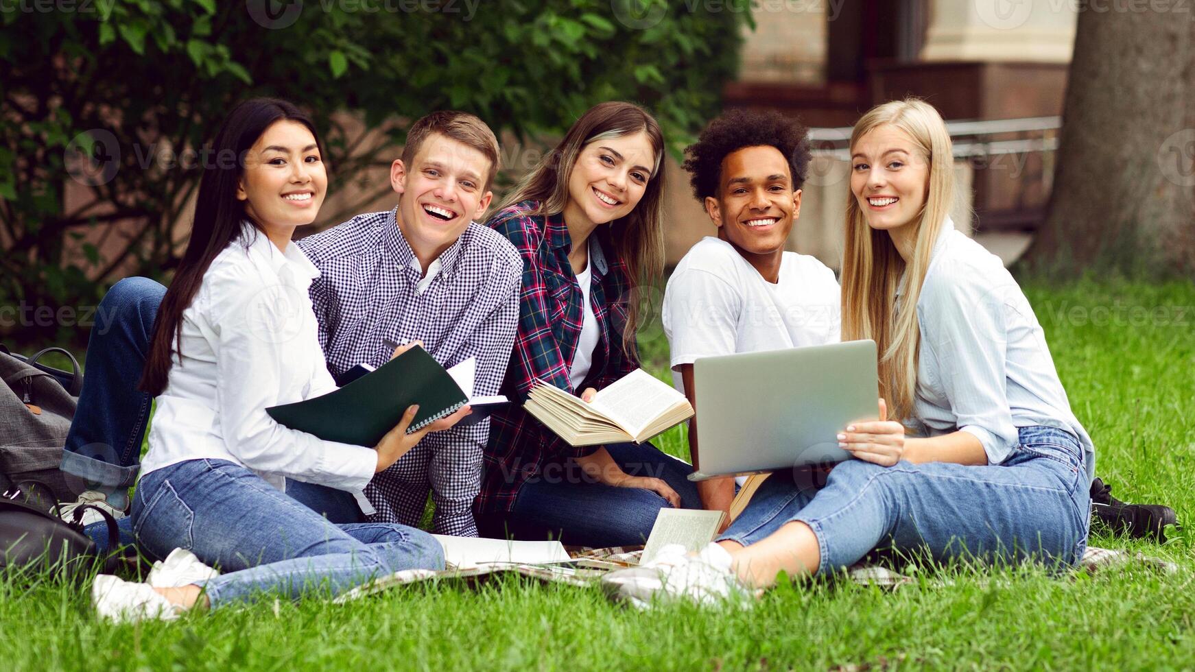 University students resting in campus, smiling to camera and preparing for classes together, free space photo