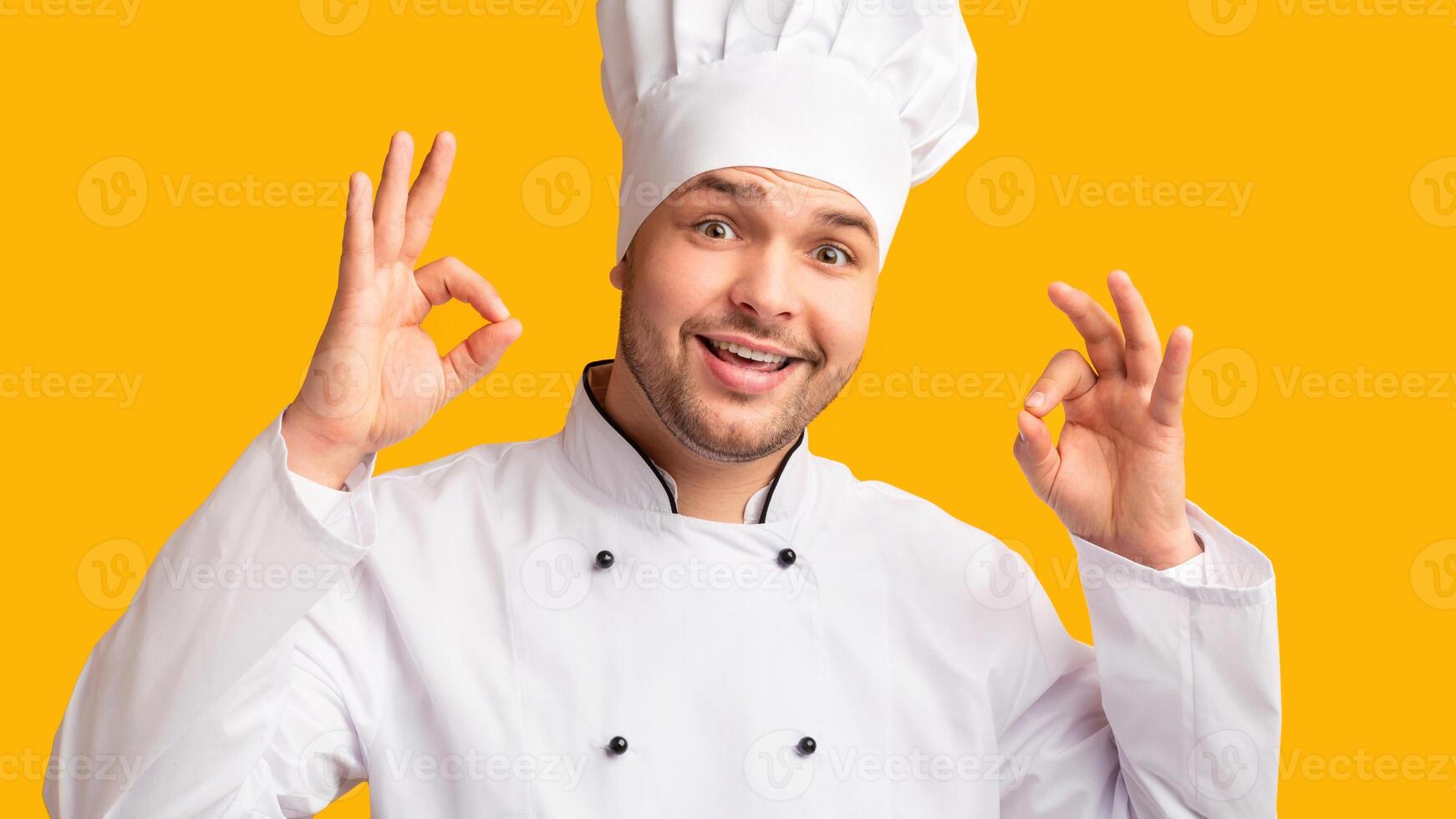 Happy Chef Man Gesturing Ok Recommending Recipe Standing On Yellow Studio Background. Panorama photo