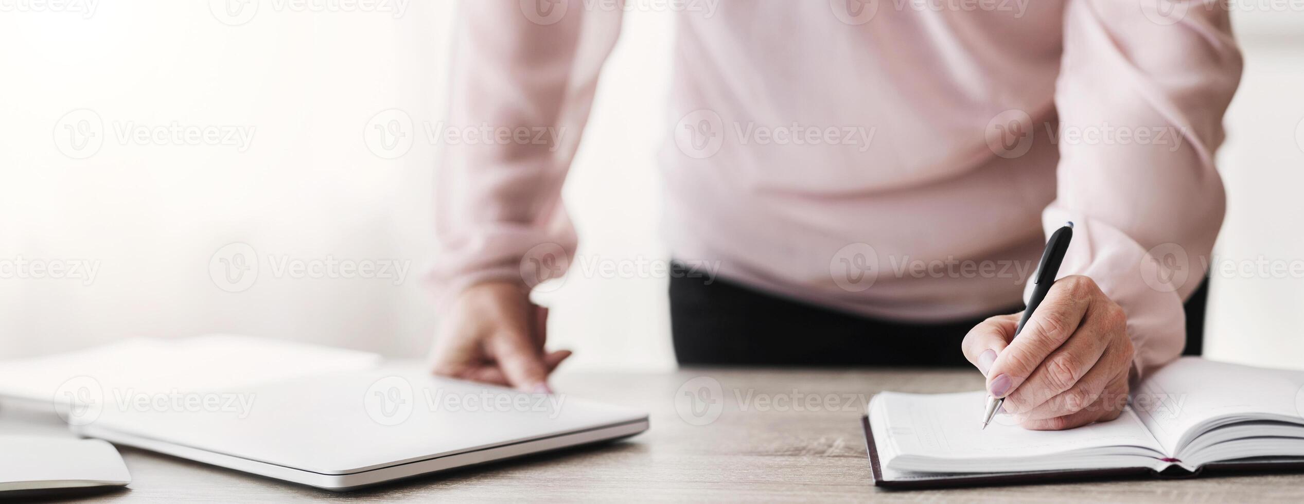 Time management concept. Senior business lady writing down tasks for working day, close up photo