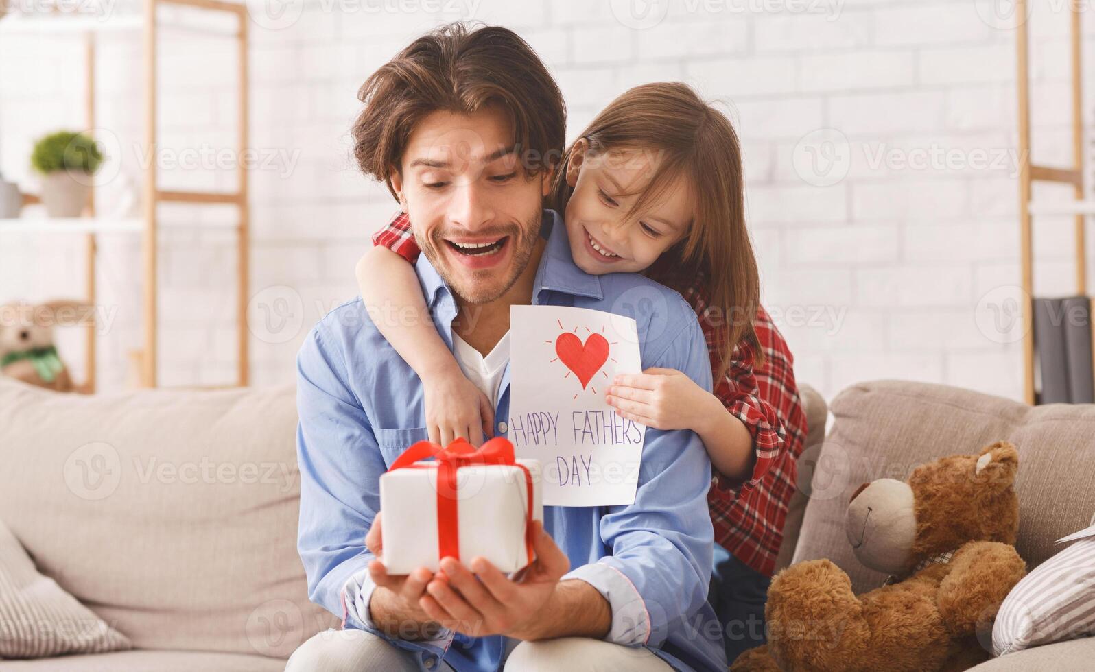 Happy Father Day, sweet girl greeting her daddy with gift and self-made card, dad is happy, copy space photo