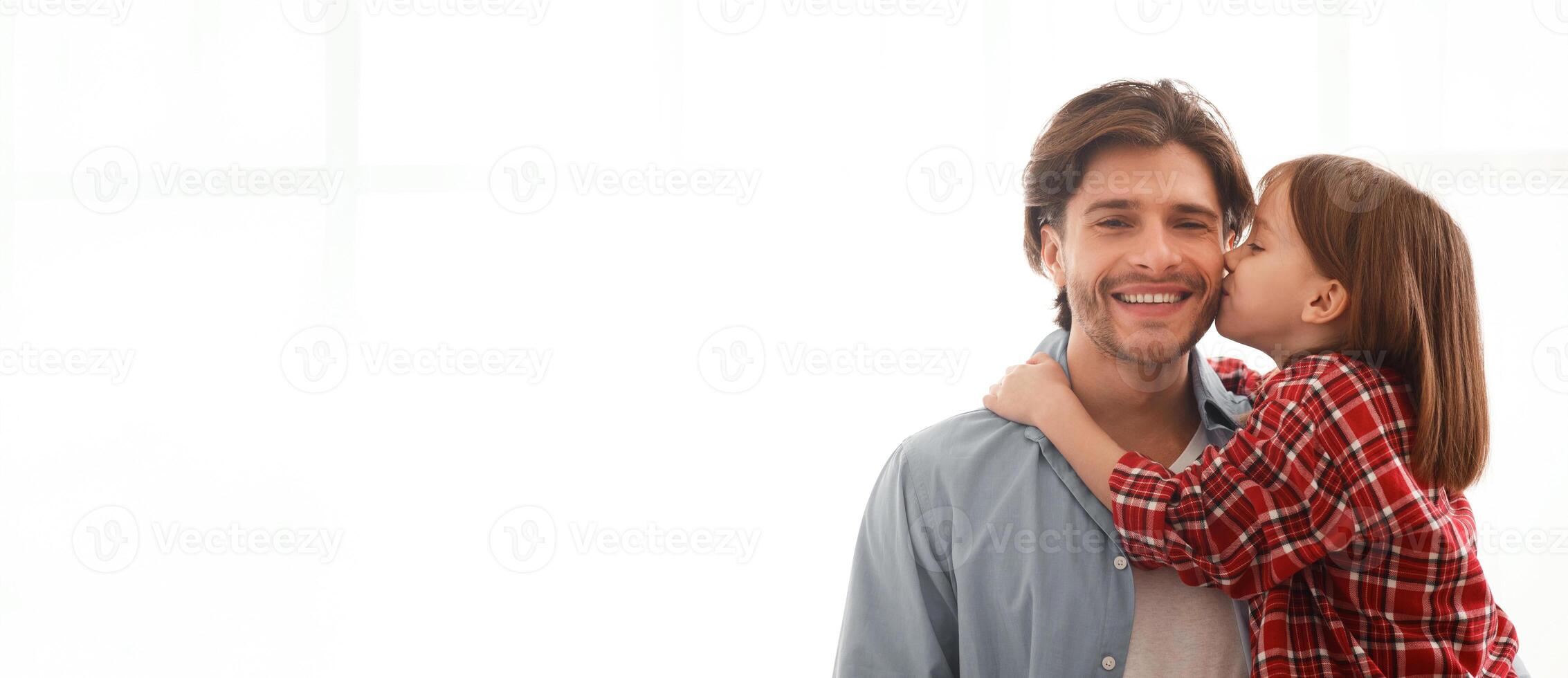 Adorable little girl kissing her happy father over white background, panorama with copy space photo