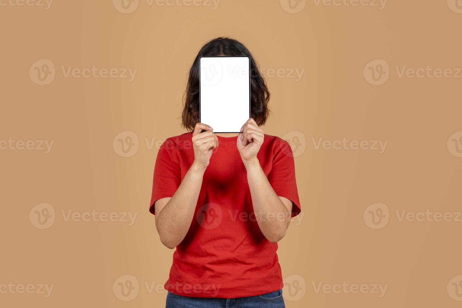 This image shows a woman in a red shirt holding a tablet in front of her face. The tablet has a white screen, which is perfect for displaying your message or design photo