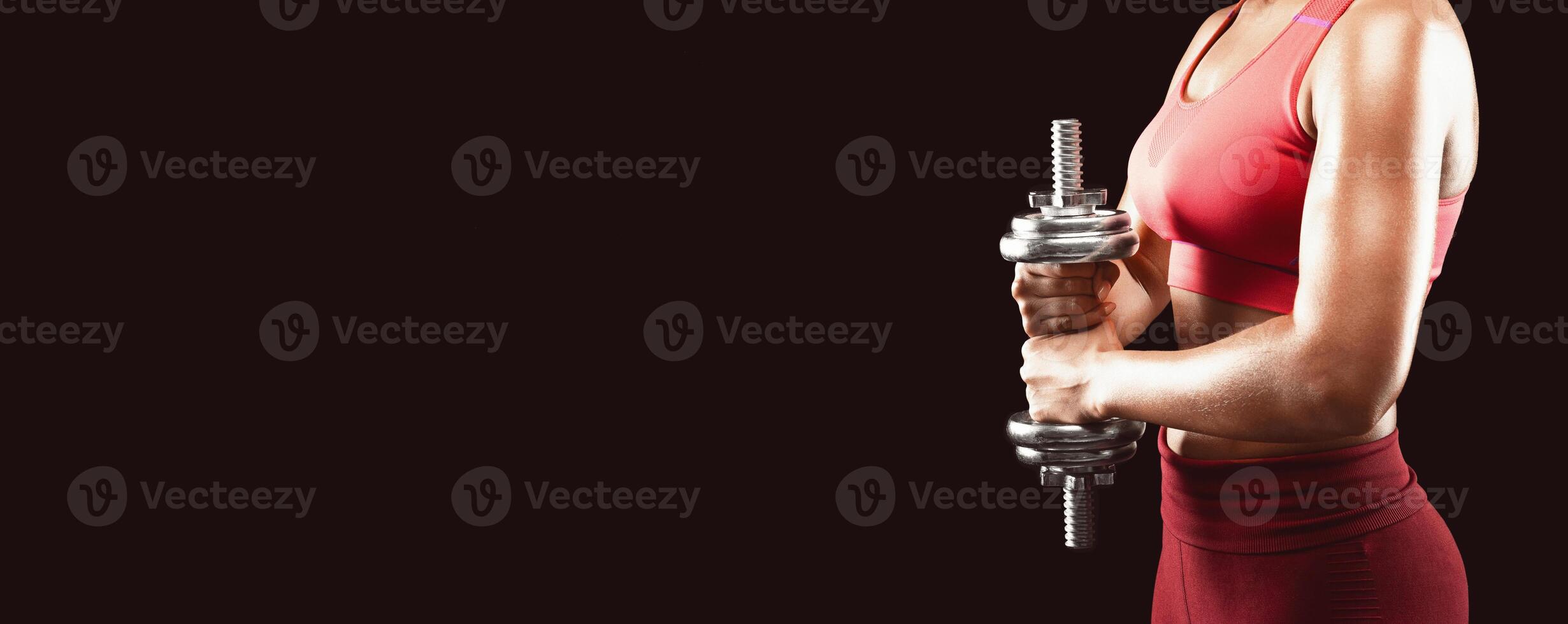 Side view of sporty african girl holding barbell over black background, making work out for shoulders, cropped, panorama with free space photo