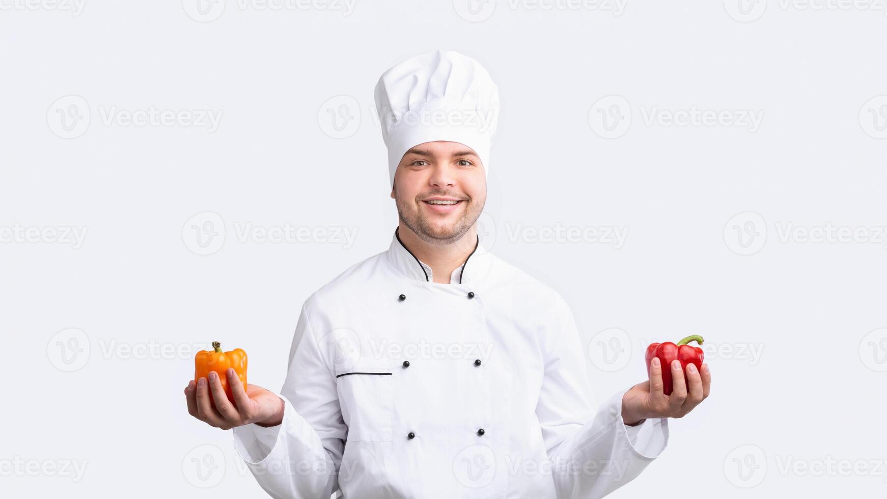 Vegetarian Recipes. Chef Guy Holding Sweet Peppers Smiling To Camera Standing On White Studio Background. Panorama photo