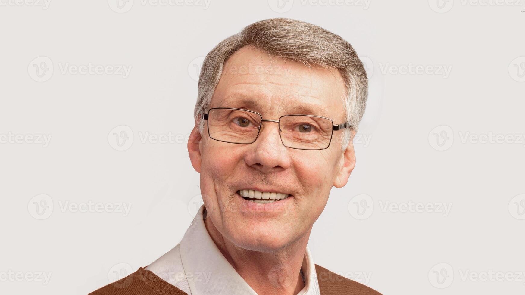 Portrait Of Smiling Senior Man Looking At Camera Posing Over White Studio Background. Panorama photo
