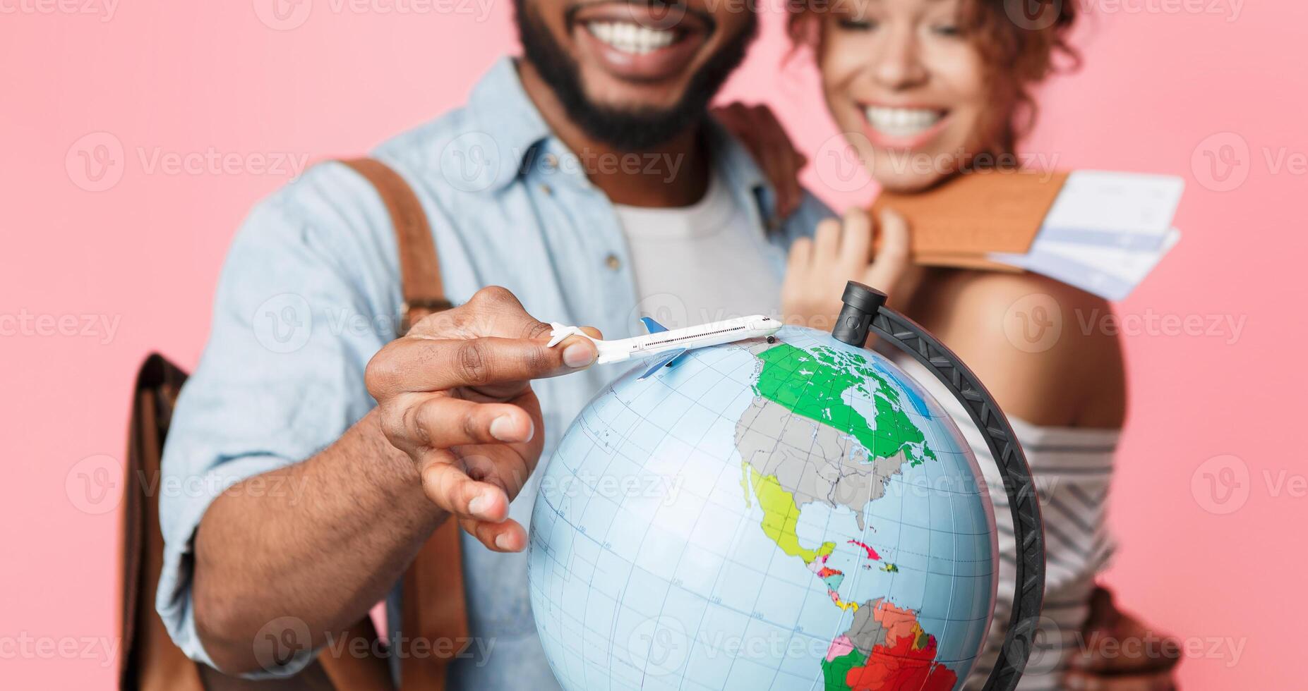 Go on an adventure. Happy couple preparing for journey, choosing route on pink background photo
