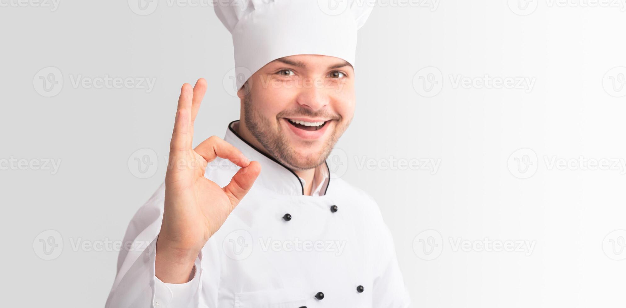 Confident Chef Man Gesturing Okay Sign Approving Recipe Standing On White Studio Background. Panorama photo