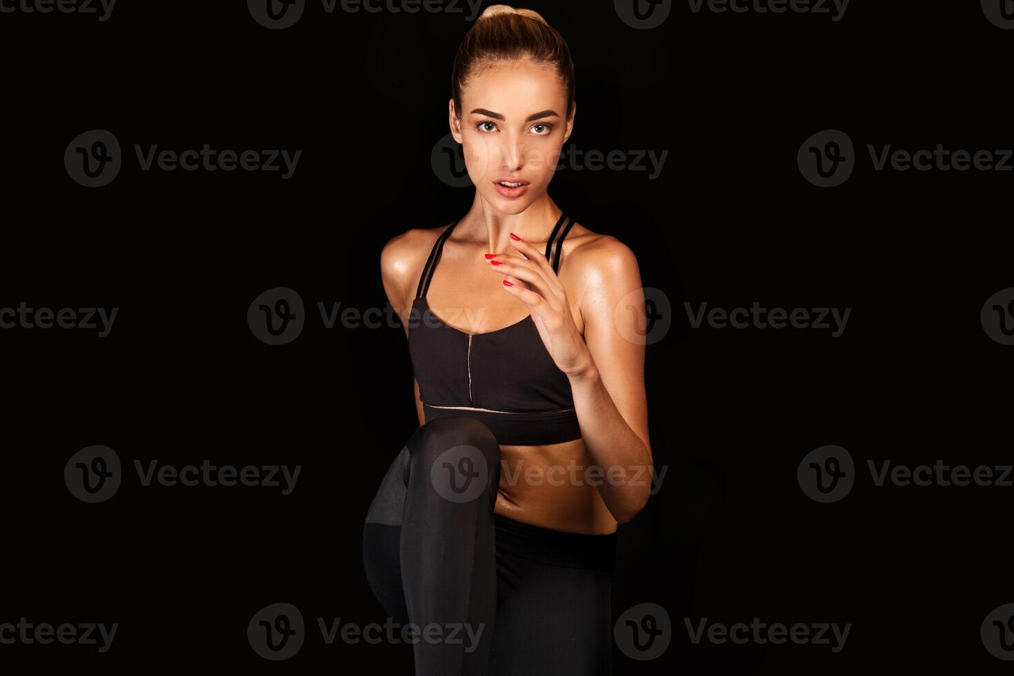 Sporty Young Lady Running In Place Over Black Background In Studio. Spot Jogging Concept. Free Space photo