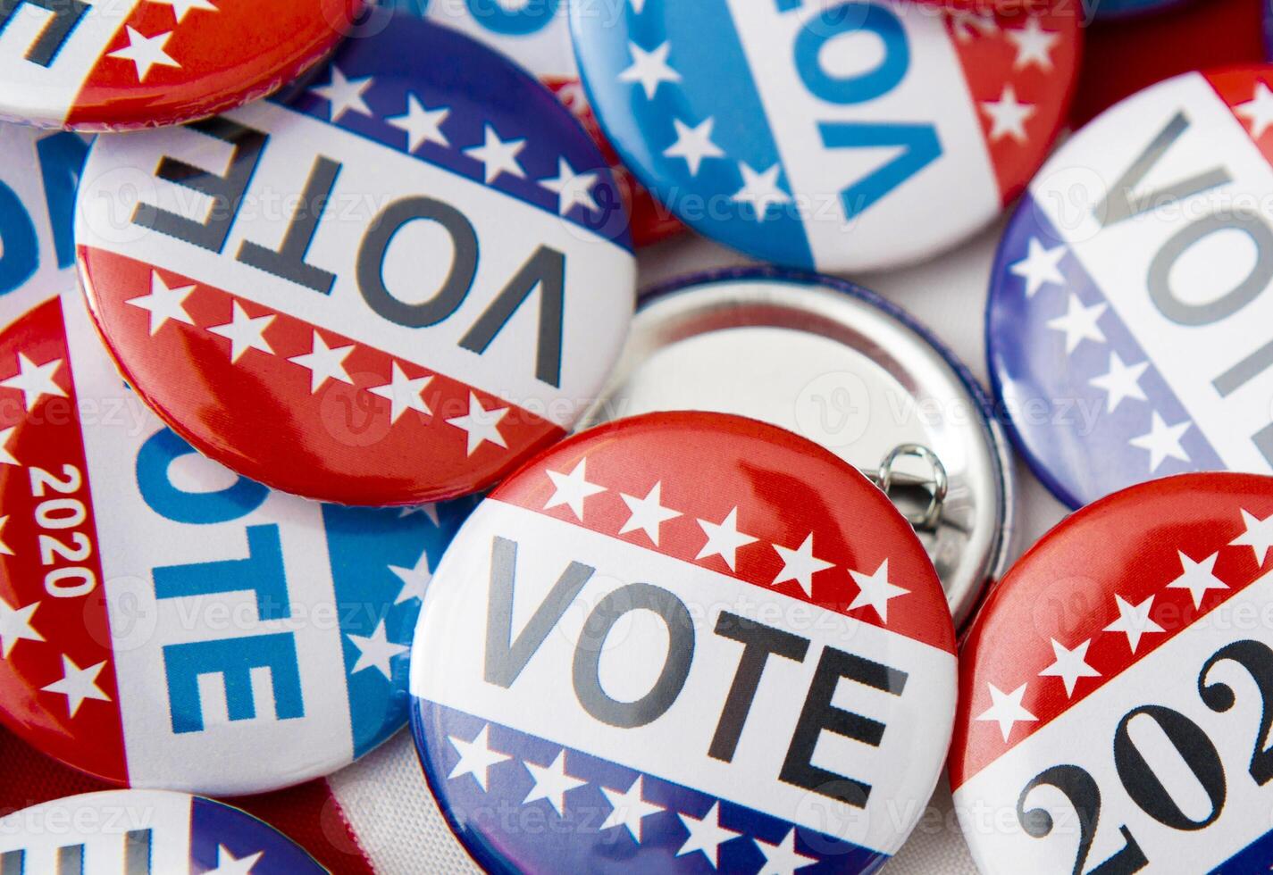 Red, white, and blue vote buttons on background with American flag, elections 2020 photo