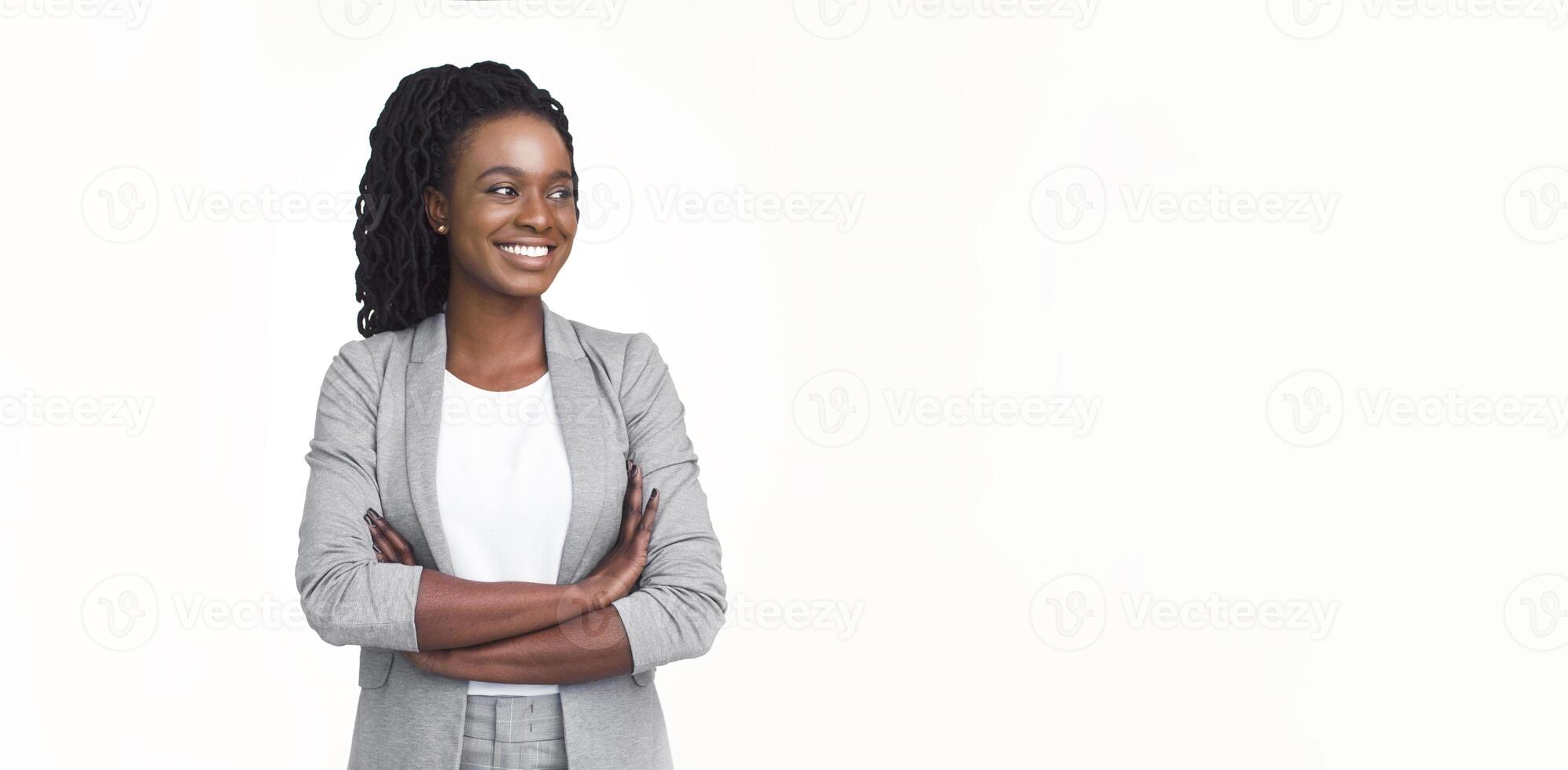 Self-confident African American corporate woman dressed in a grey blazer and glasses, isolated on a white background, with plenty of copy space for text. photo