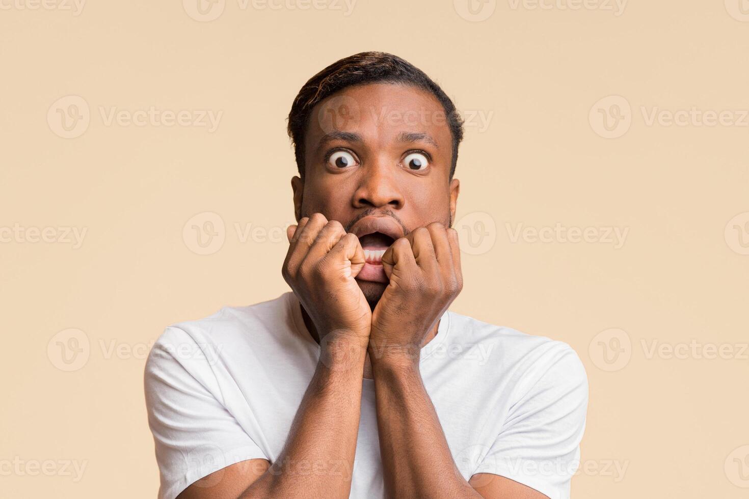 Omg. Scared And Shocked African American Man Looking At Camera Touching Face Standing Over Yellow Background. Studio Shot photo