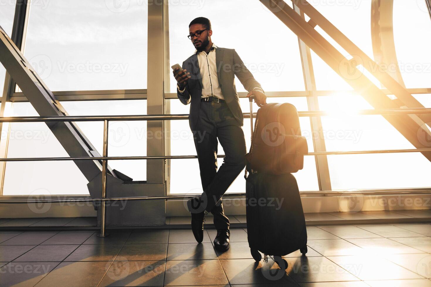 Waiting for Flight. Businessman with Baggage Standing in Airport Terminal, Free Space photo