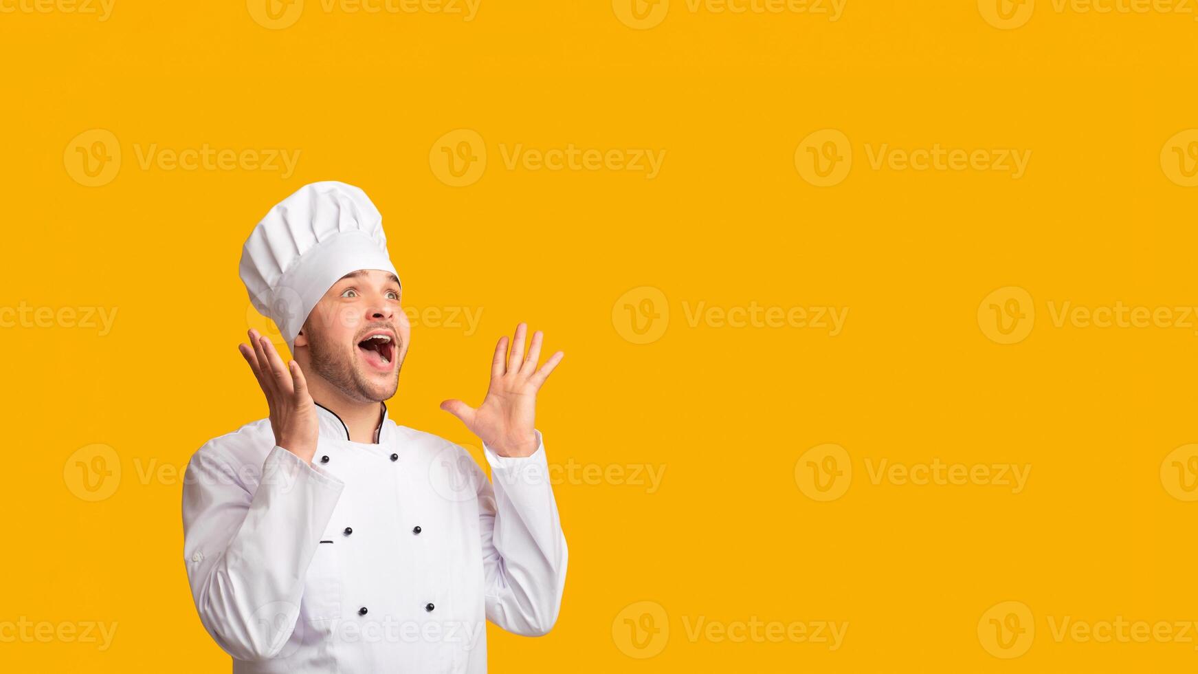 Excited Cook Man Screaming Holding Hands Near Mouth Standing On Yellow Studio Background. Panorama, Empty Space photo