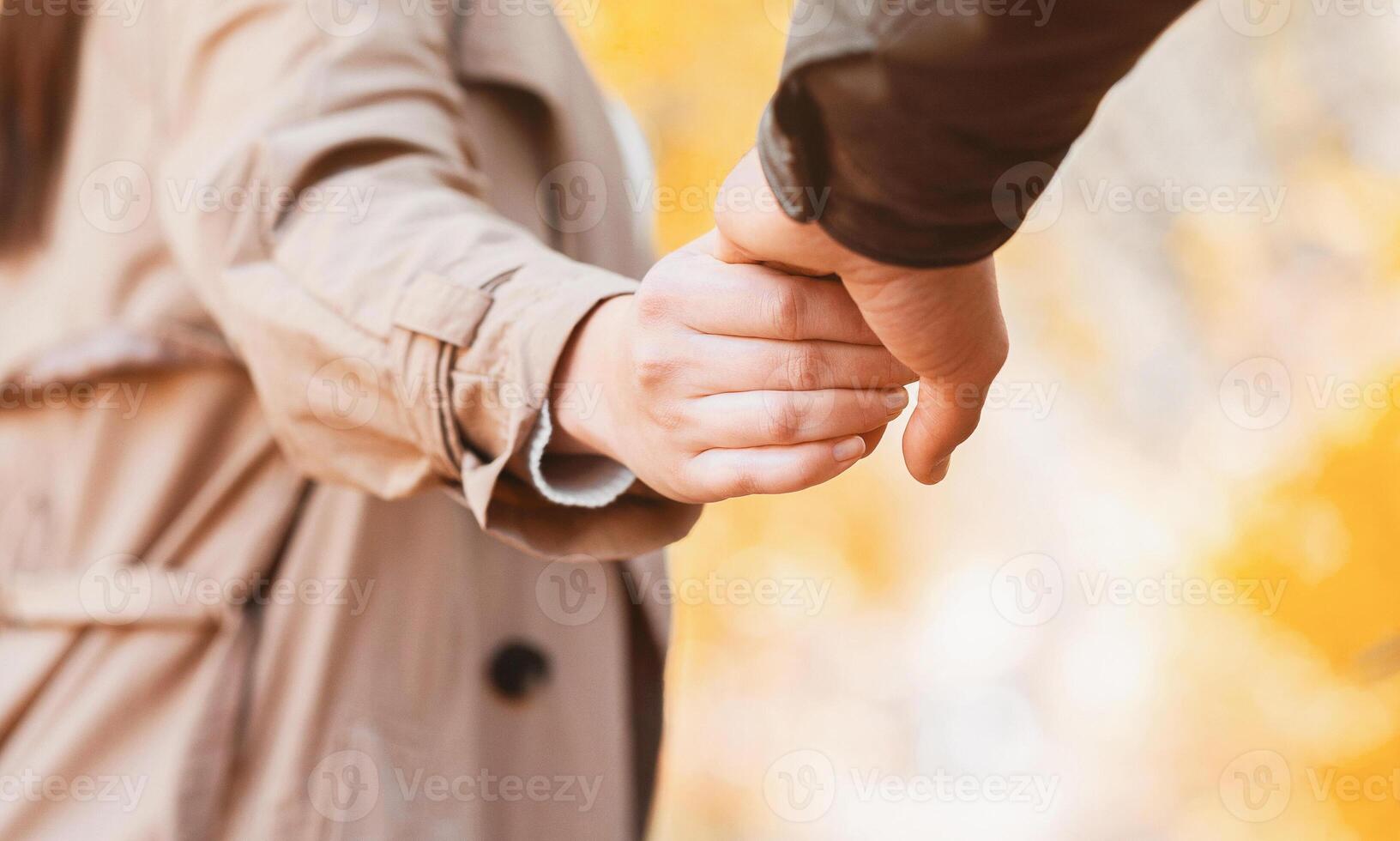 Emotional girl in love guiding her boyfriend by autumn forest, close up photo