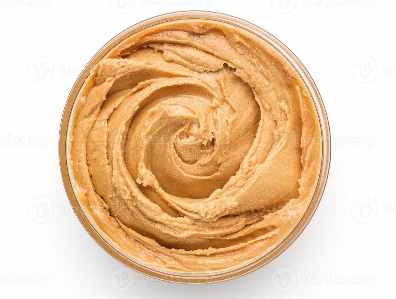 Bowl of peanut butter isolated on white background, top view photo