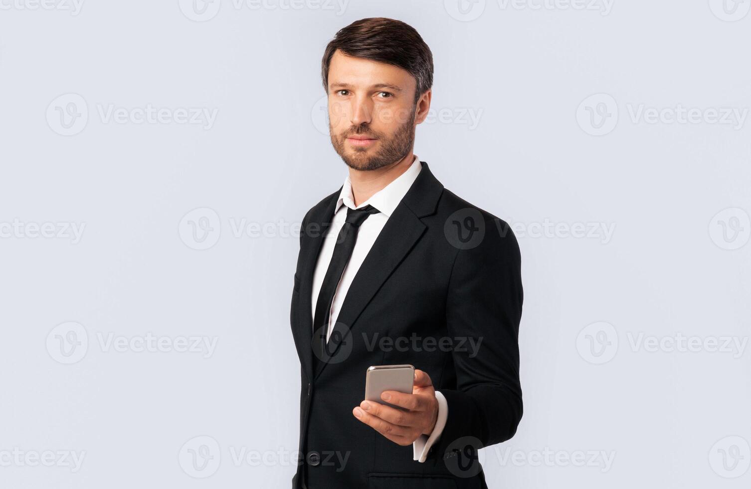 Call Me Concept. Businessman Holding Mobile Phone Standing Over White Studio Background. Empty Space, Isolated photo