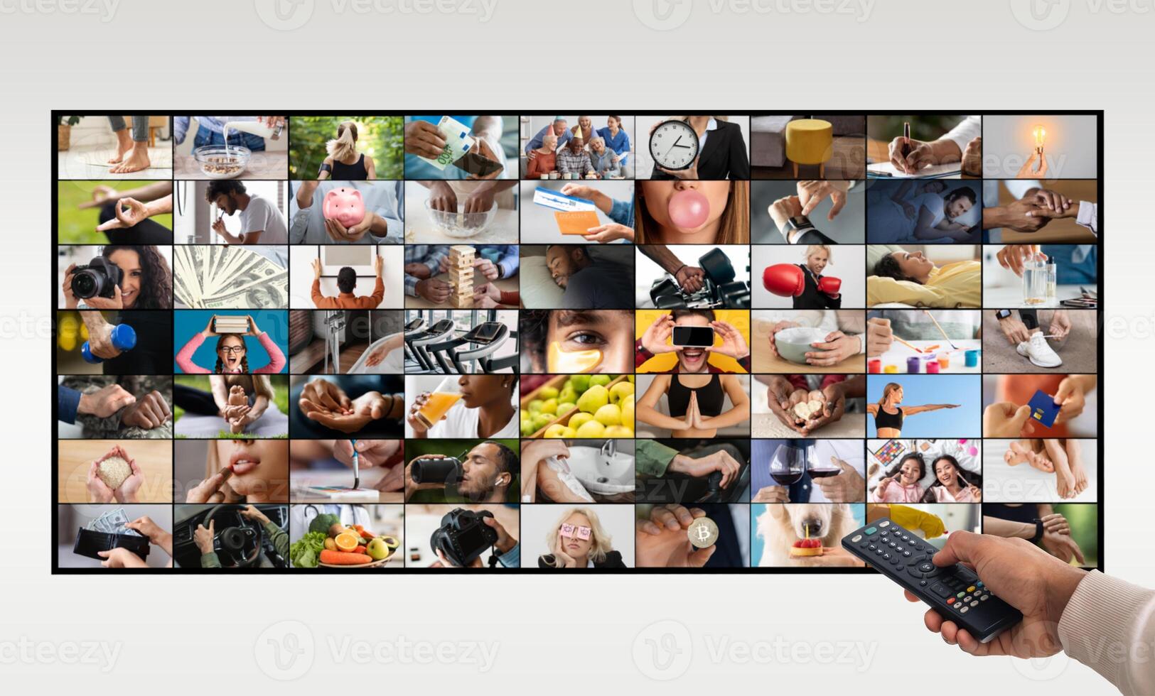 A hand holding a remote control is pointing at a large television screen. The screen is displaying a grid of small videos, each depicting a different activity photo
