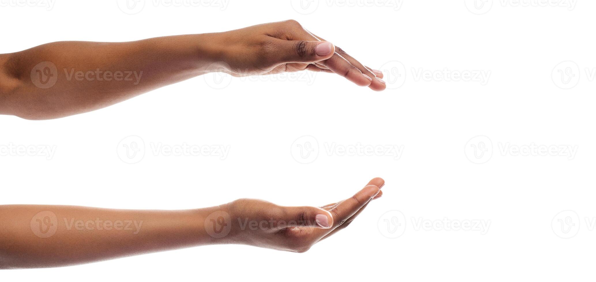 Black Lady's Hands Holding Or Giving Something Invisible Isolated On White Studio Background. Panorama, Empty Space photo