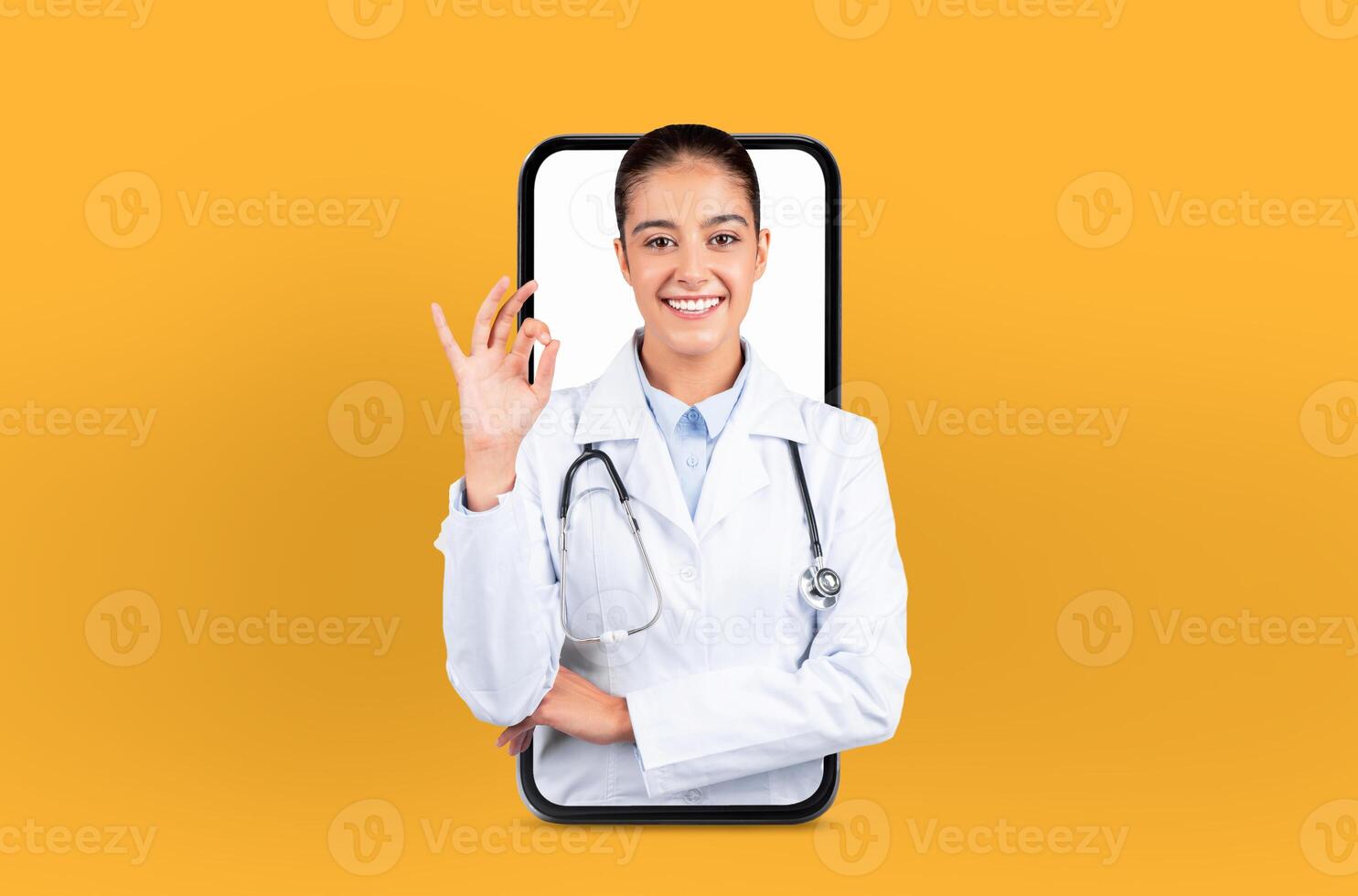 Depicting digital health technology, a young woman stands as a doctor within a smartphone, embodying the future of telehealth, showing okay gesture photo