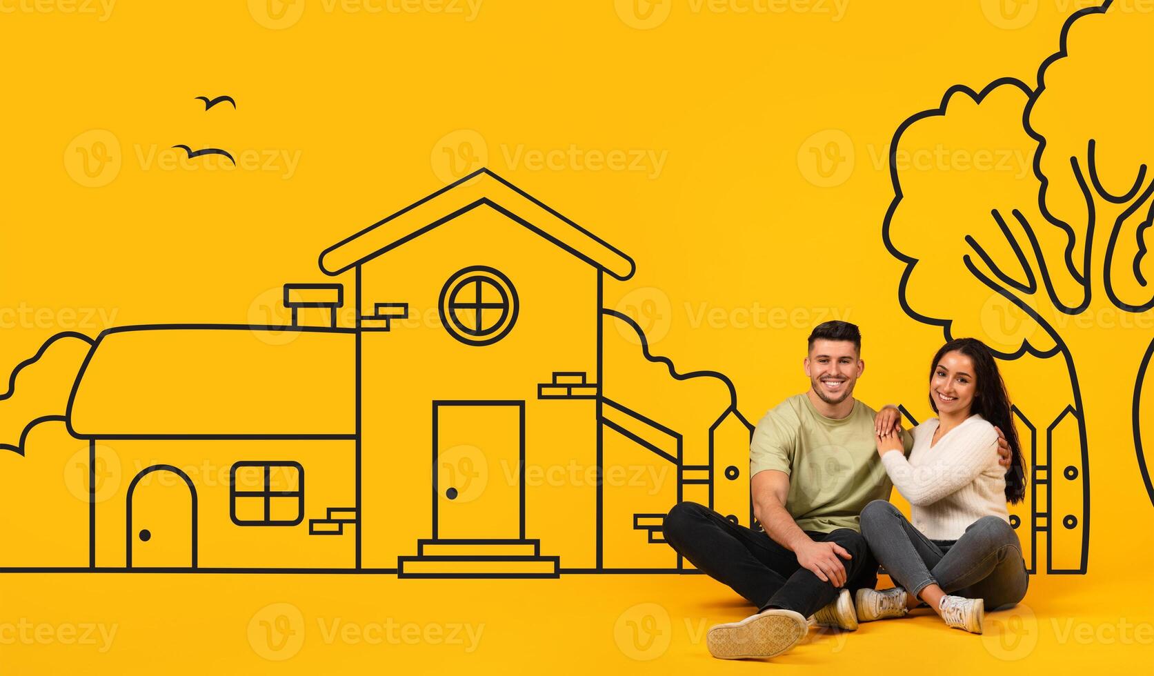 A cheerful young couple is sitting casually with their backs leaning against each other, displaying a sense of comfort and happiness, illustrated house behind them photo