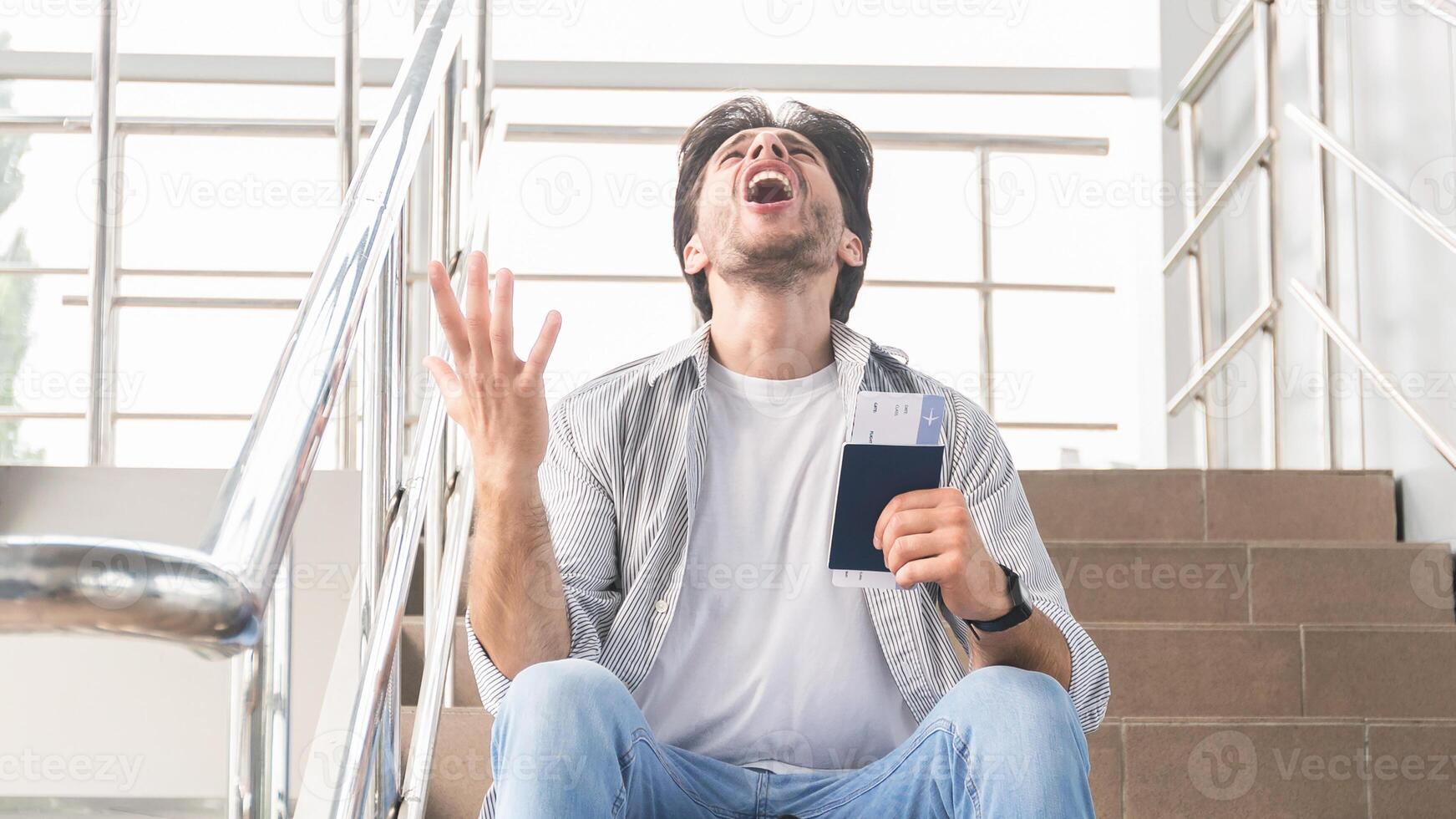 Lost Flight. Desperate Man Sitting In Airport With Passport, Border Closed Due To Coronavirus, Guy Emotionally Yelling Why, Panorama With Free Space photo