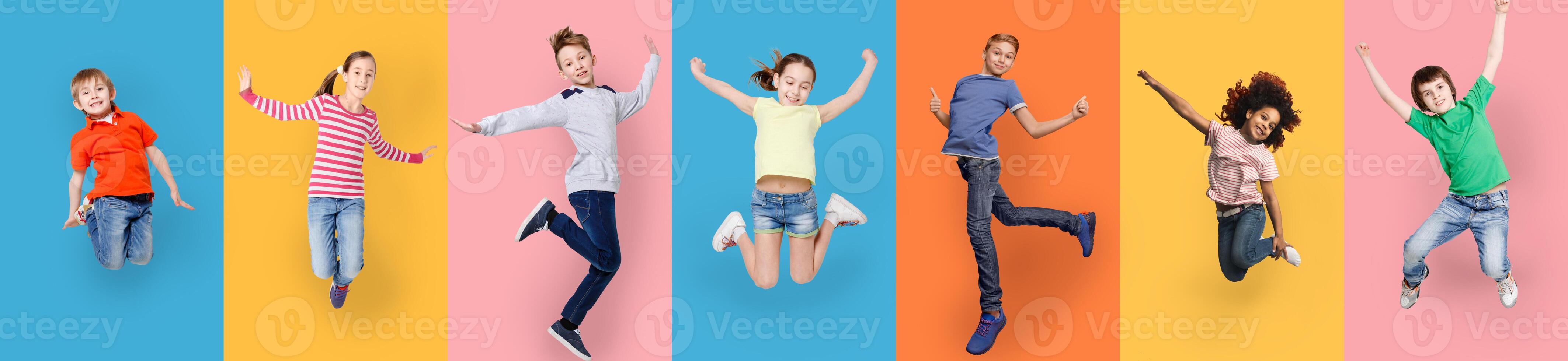 Happy Diverse Kids Jumping Posing Over Different Colorful Backgrounds. Collage With Joyful Multiracial Boys And Girls Jump Together. Carefree Childhood Concept. Panorama photo