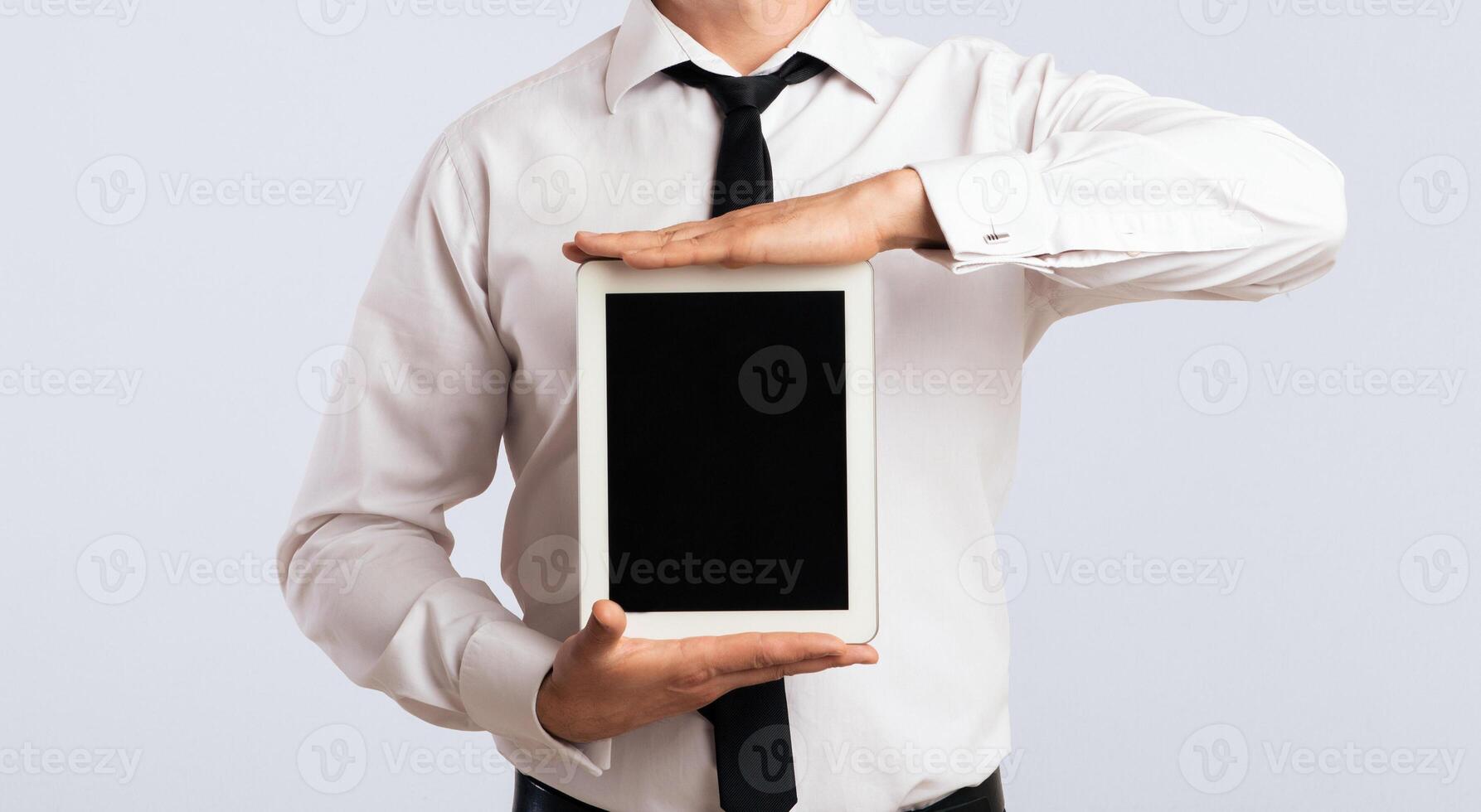 Business App. Cheerful Guy Showing Blank Tablet Computer Screen On White Background In Studio. Mockup photo