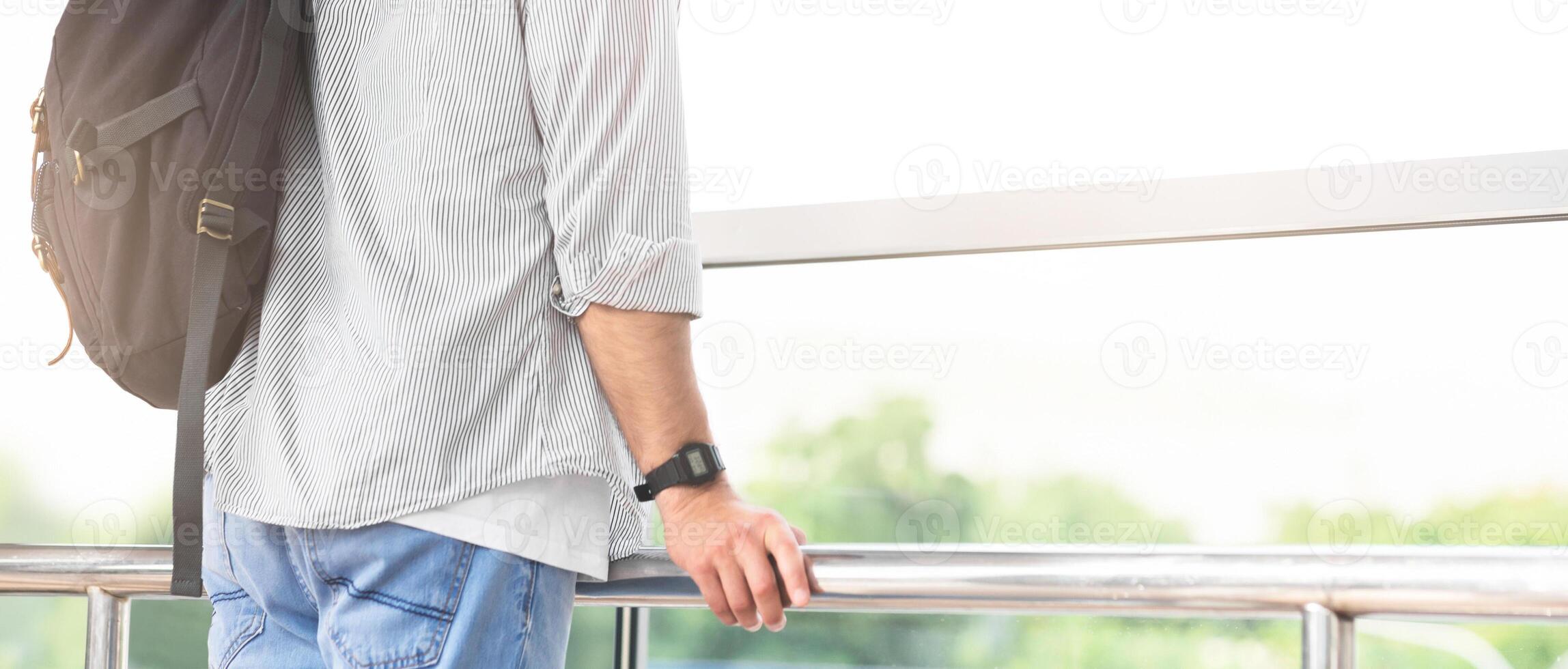 Enjoying new view. Happy tourist looking at airport window at new location, empty space photo