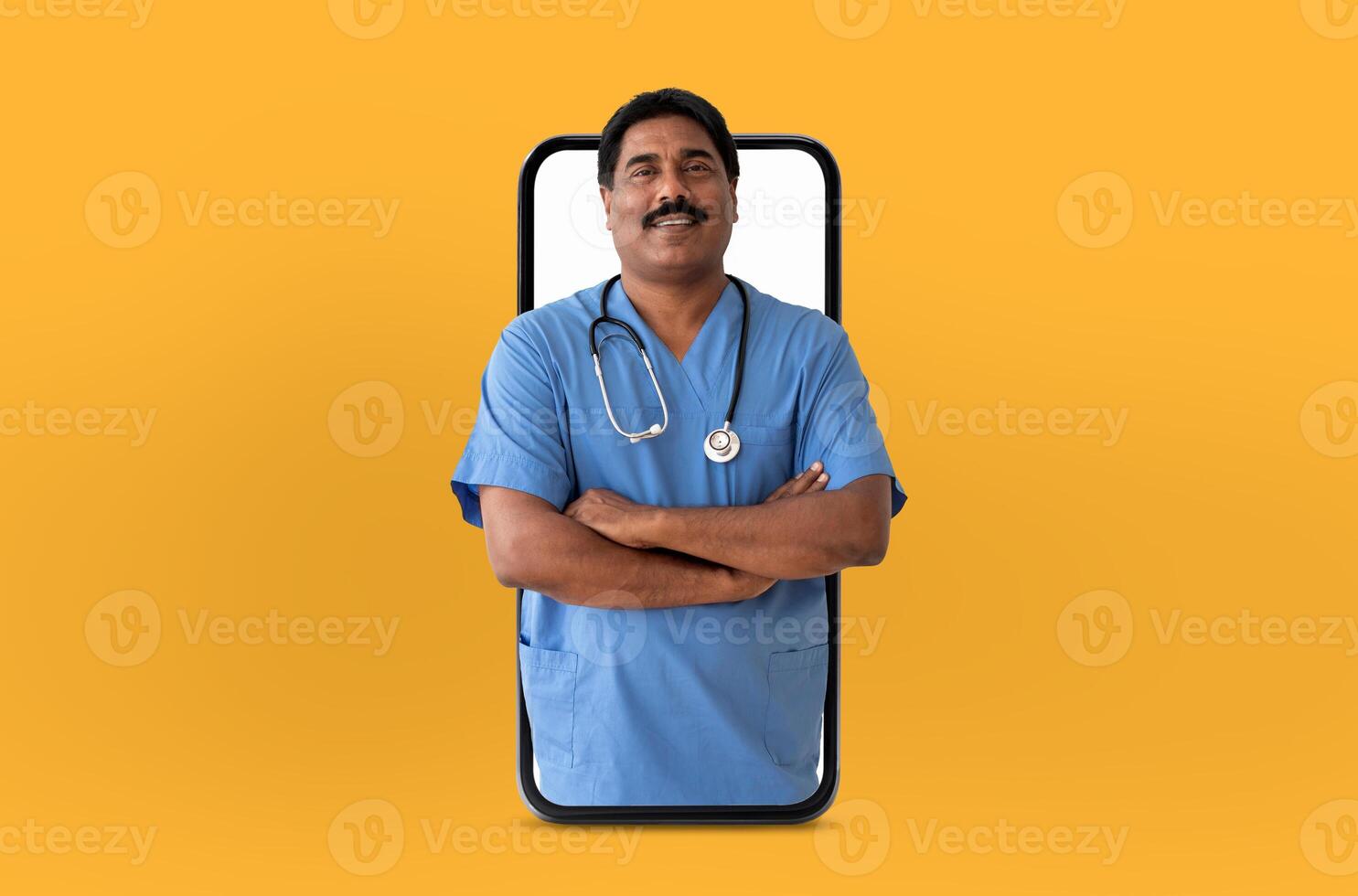 A cheerful Indian man doctor wearing blue scrubs and a stethoscope stands with arms crossed, seemingly emerging from a smartphone screen on a vibrant yellow background photo