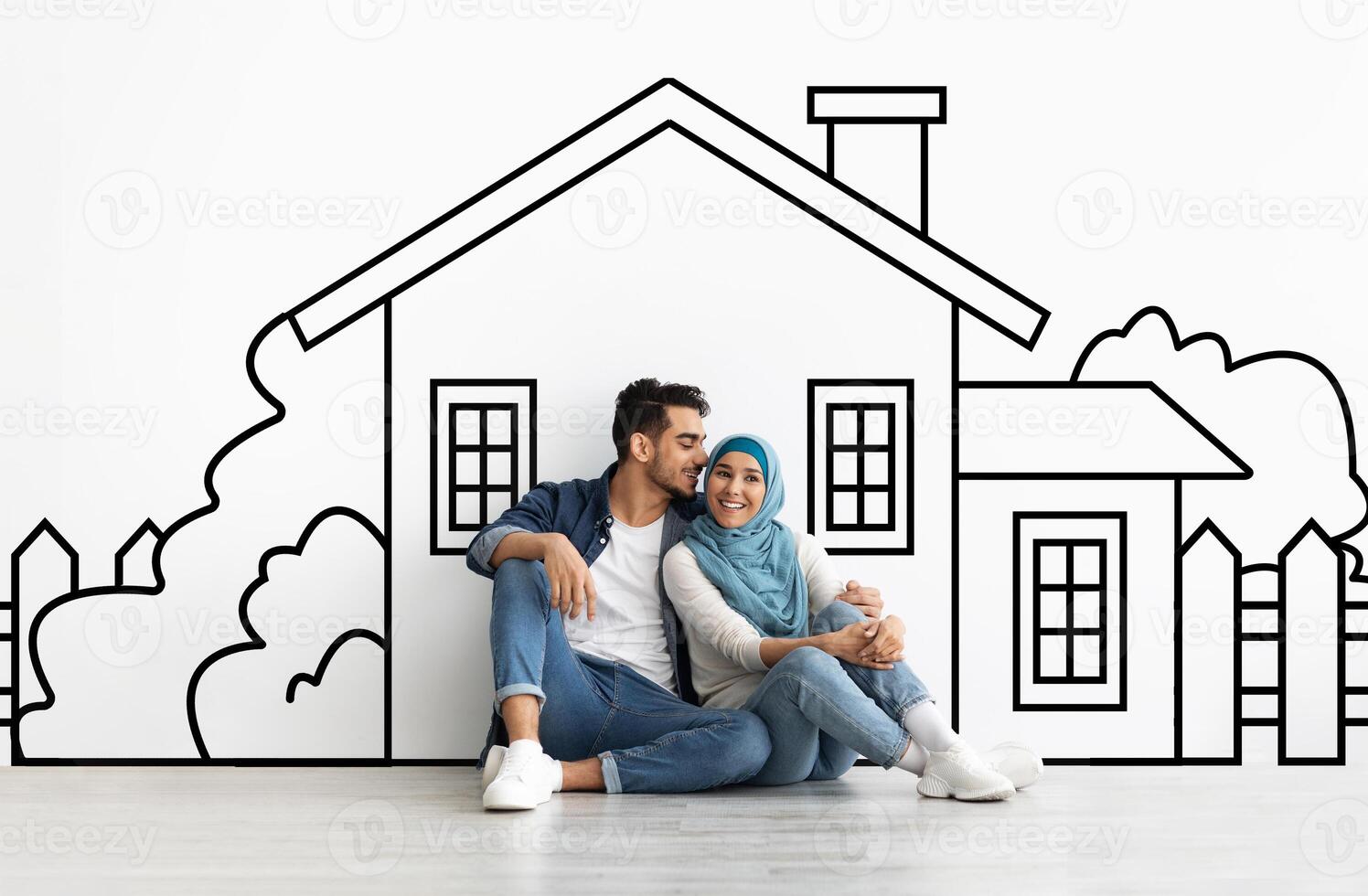 Loving millennial muslim couple planning their dream home against a hand-drawn house sketch on white wall background. Mortgage concept photo