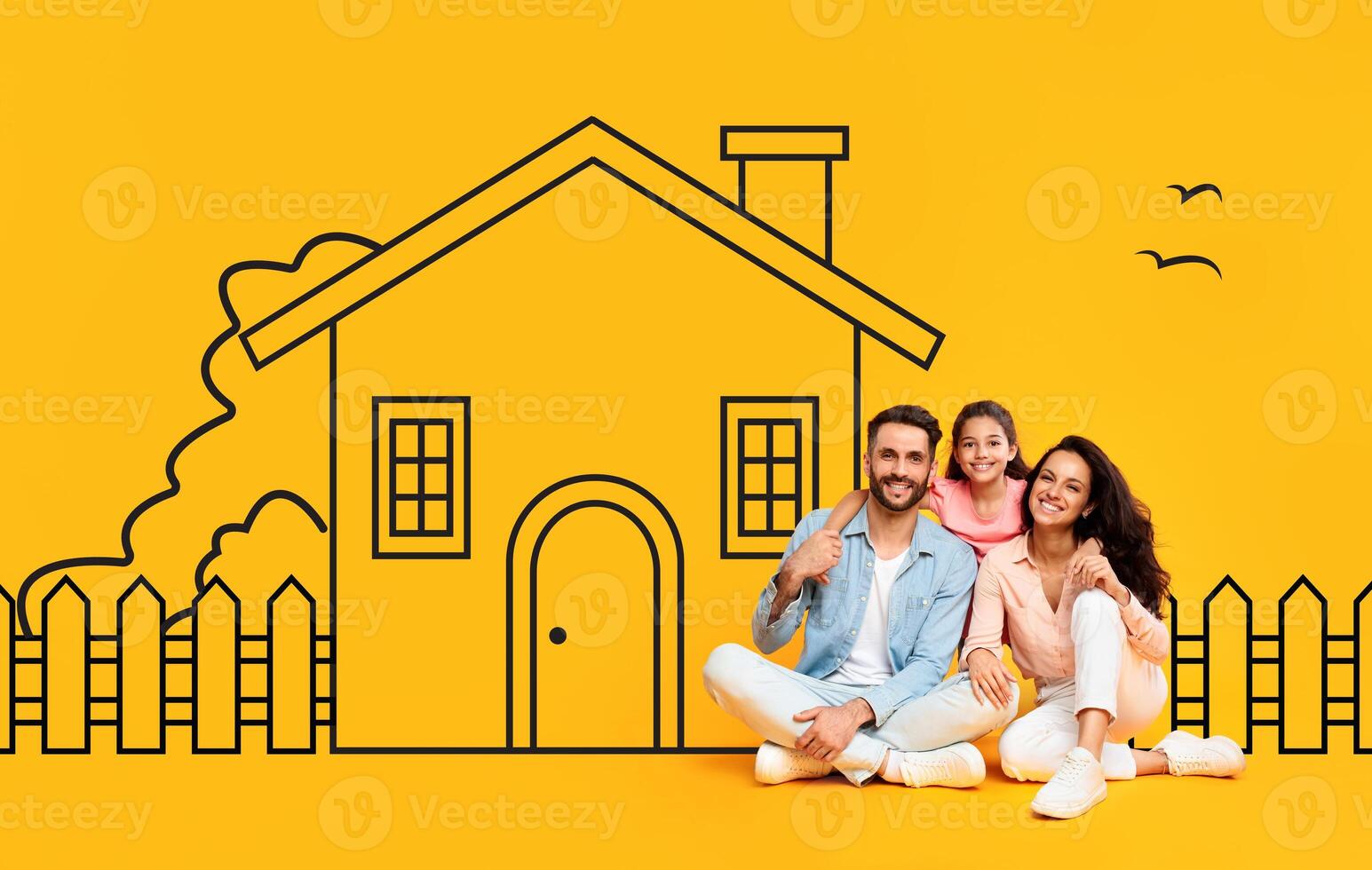 A happy family, consisting of a father, mother, and daughter, are seated close together in casual attire against a vivid yellow backdrop featuring a hand-drawn illustration of a house photo