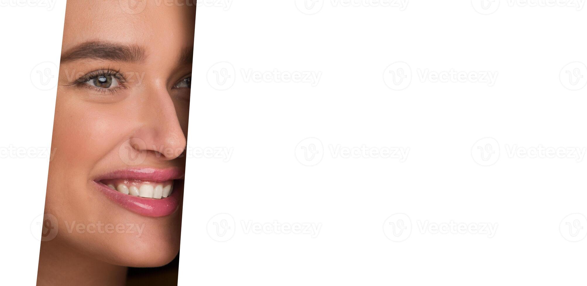 The image shows a woman face peeking through a perfectly circular hole in a white piece of paper. Her features are visible, framed by the edges of the hole. photo
