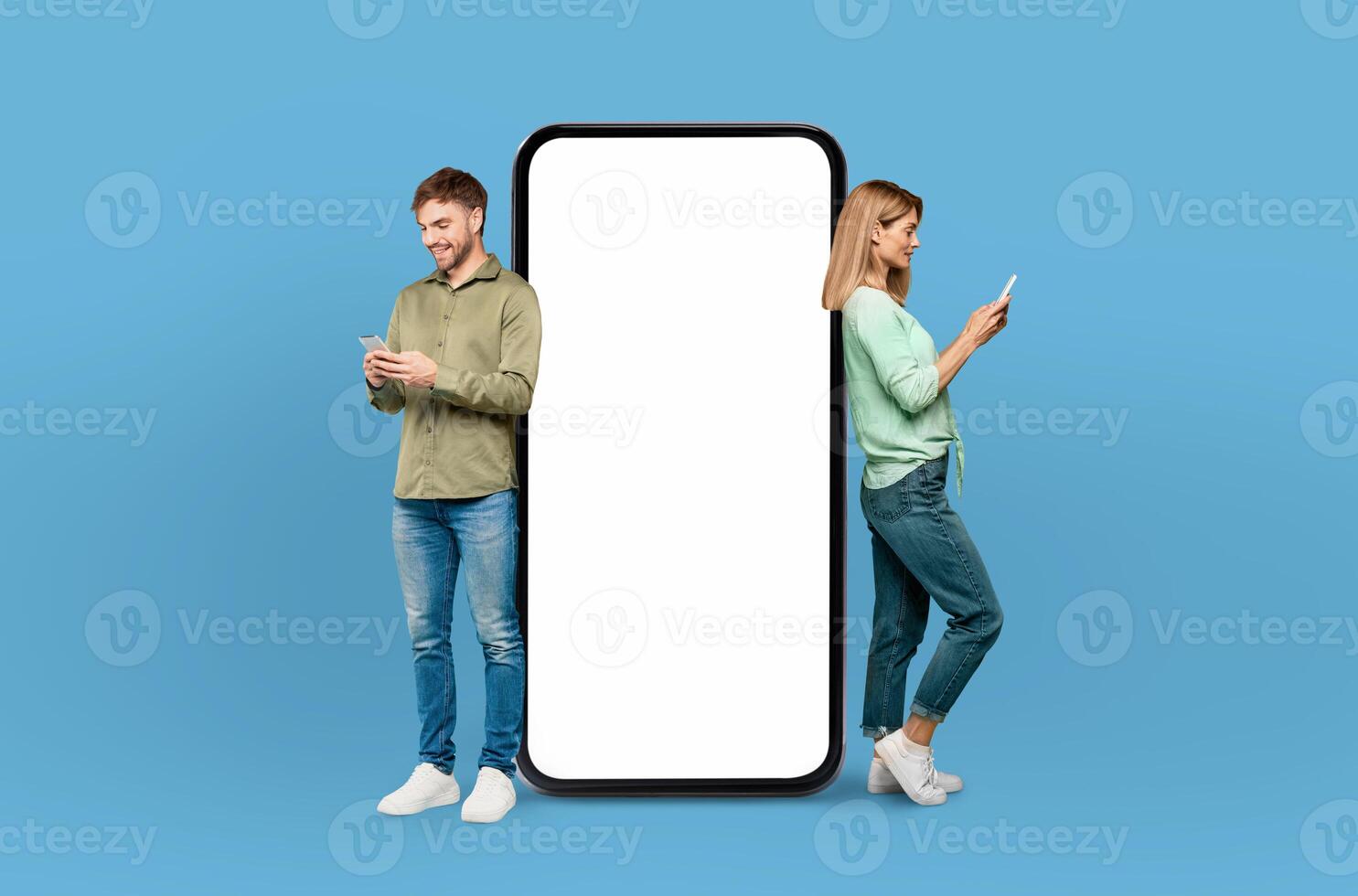 Illuminated by the cool blue backdrop, the European young man and woman share a smile, enhancing the visual appeal of the blank smartphone screen beside them. photo