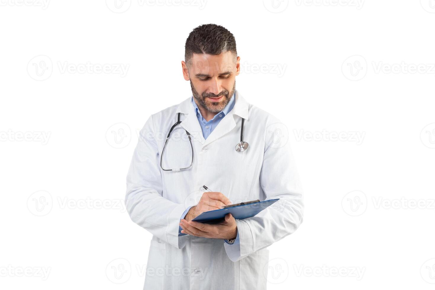 A man doctor, dressed in a white coat with a stethoscope around his neck, is writing notes on a clipboard in a well-lit medical office. He appears focused on his work. photo