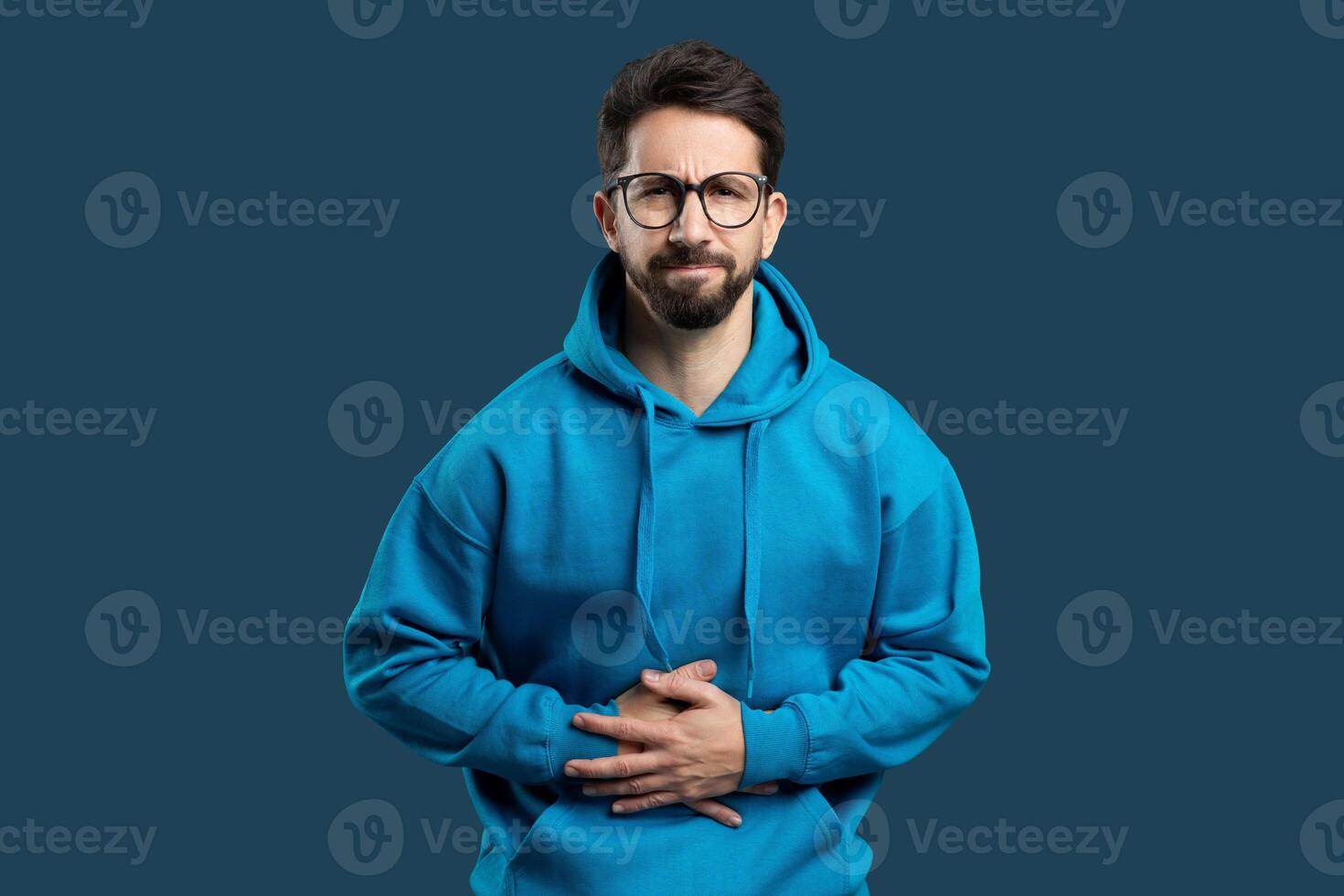 Photo portrait of man grimacing touching stomach injury poisoning disbalance diarrhea isolated on bright blue color background