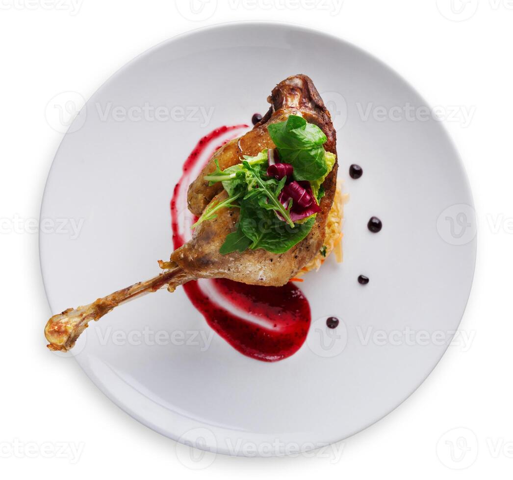 Exclusive restaurant meals. Duck confit with braised cabbage, baked apple and cranberry sauce, isolated on white background, top view photo