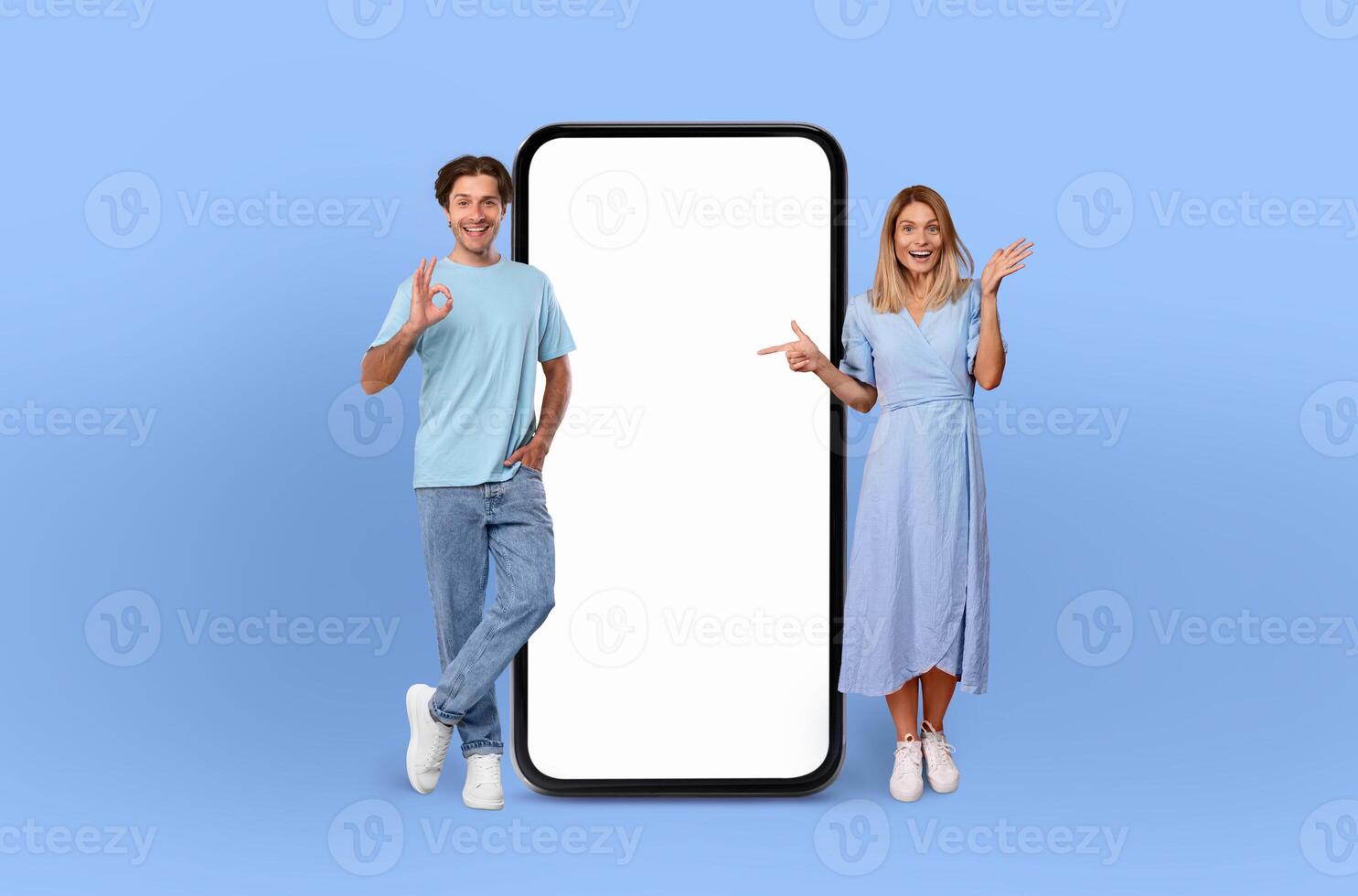European couple smiles are infectious as they stand side by side, presenting a large smartphone with a pristine, empty screen, ready to capture the imagination. photo