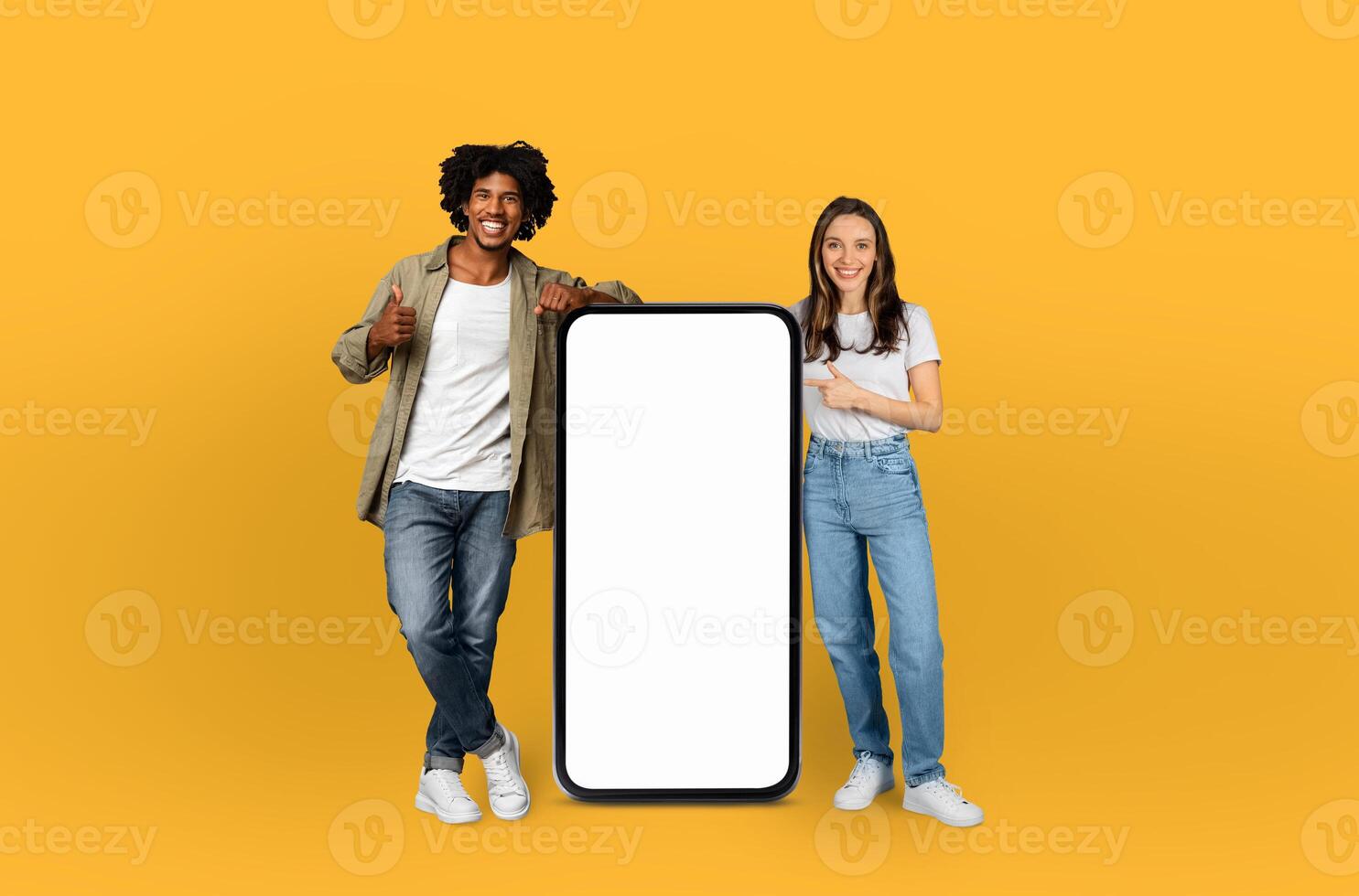 Two individuals standing beside a blank screen, appearing focused and engaged. The screen is empty, creating a clean and simple backdrop for potential content or presentations. photo