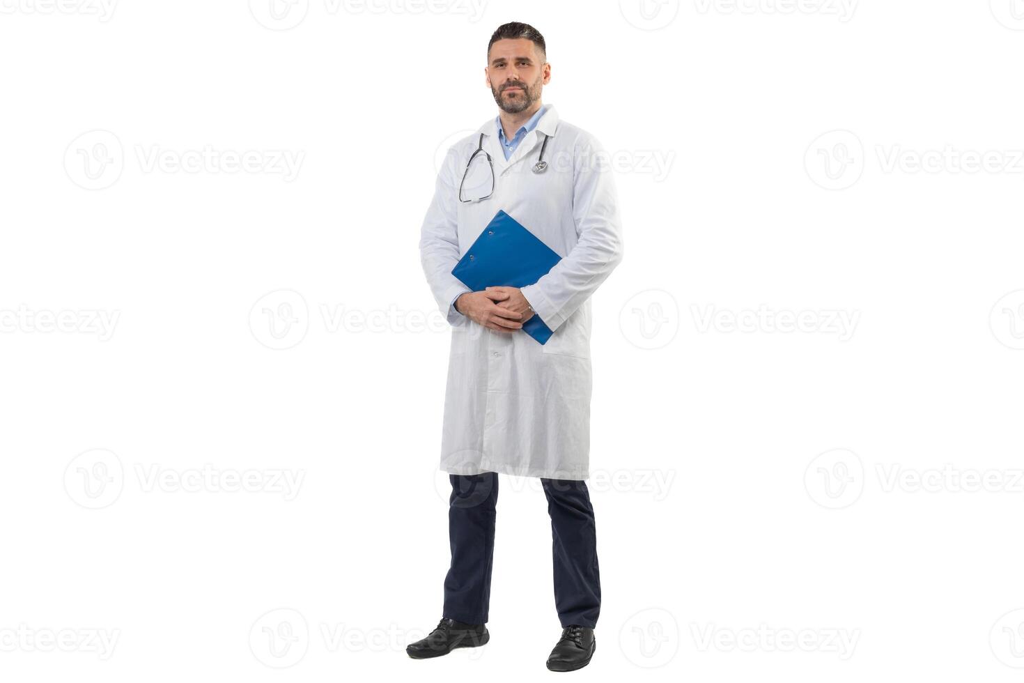 A man doctor is standing with a blue folder in his hands while wearing a white lab coat. He looks composed and professional, implying readiness for medical consultations. photo