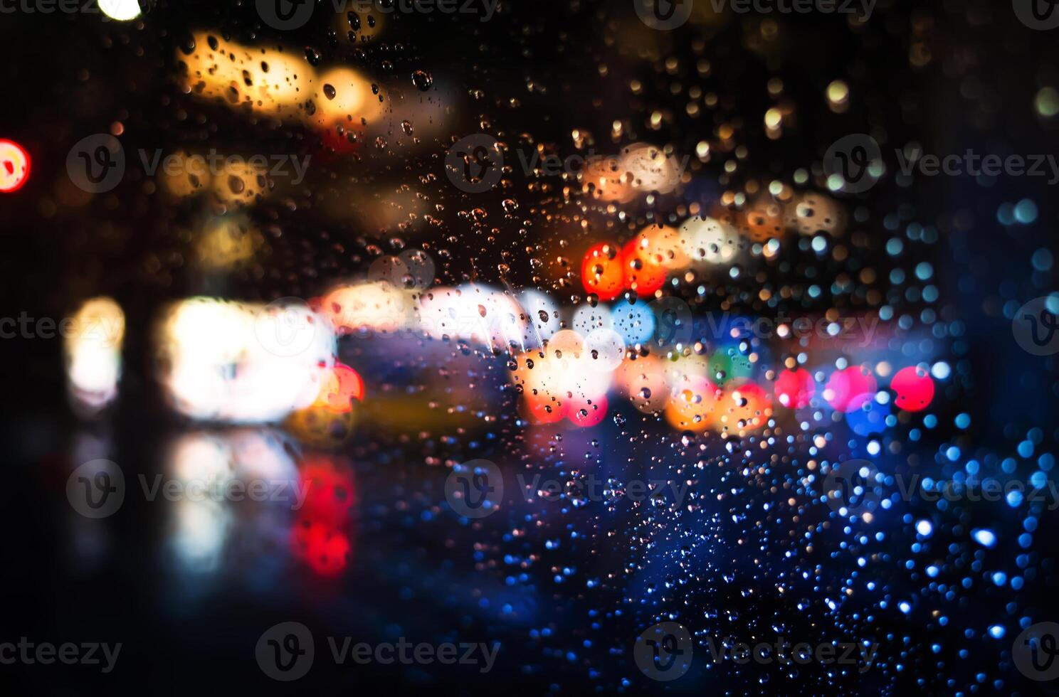 Rainy night with blurred lights on the street photo